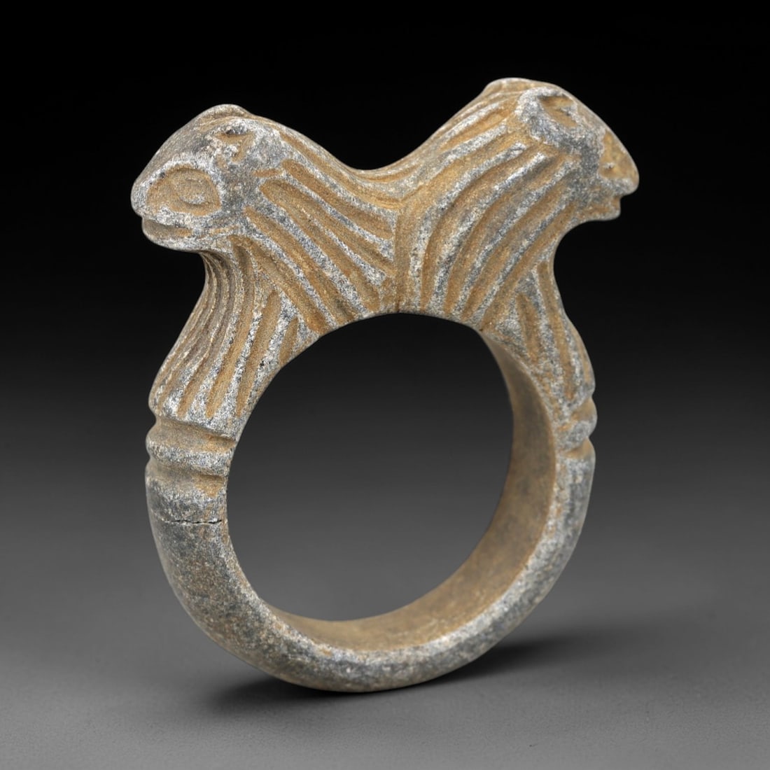 Ancient Steatite Double-Headed Animal Ring - Near Eastern Protective Amulet, 87AM: Carved from gray steatite with warm patination, this ancient Near Eastern ring features a double-headed animal motif (likely rams or ibexes) with incised linear striations defining the fur and facial 