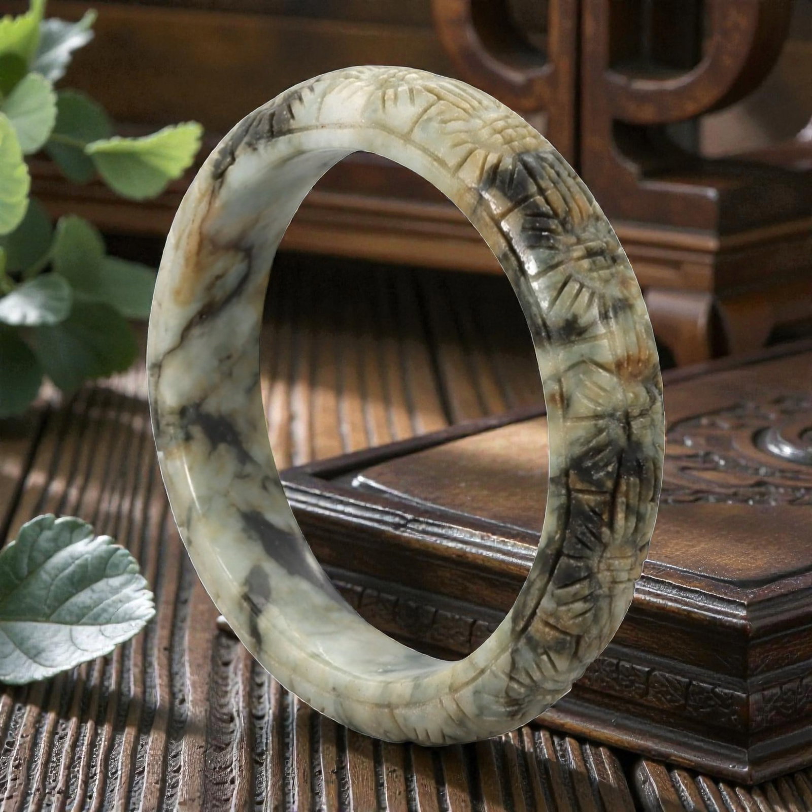 Natural Burmese Type A Carved Jadeite Jade Bangle Bracelet, 20th Century, 53ZL: A fine jadeite bangle of flattened circular form, intricately carved in relief with a continuous band of foliate and floral motifs. The stone displays a captivating variegated palette, featuring a pal