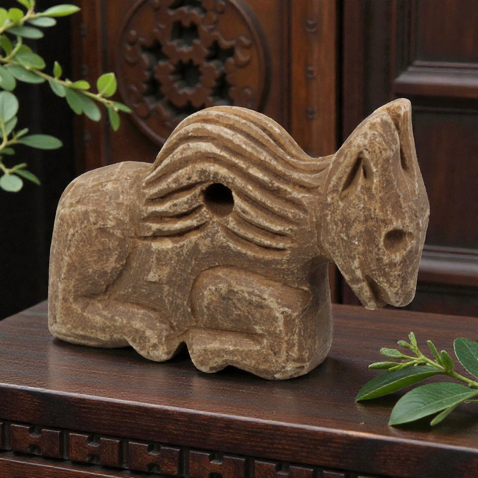 Ancient Near Eastern Style Stone Recumbent Zoomorphic Equine Amulet, 87WM: A single ancient Near Eastern-style stone amulet, carved in the form of a recumbent equine (horse). The piece features stylized, incised wavy lines representing the mane, simplified facial features, a