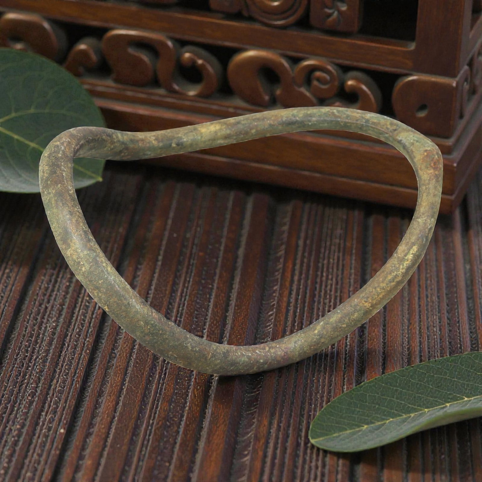 Ancient Bronze Anklet - Roman Penannular Bangle, 29BN: A penannular bronze anklet of ancient Roman origin, formed from a thick, rounded bronze band. The piece has no visible closure mechanism, indicating it was likely worn as a slip-on anklet. The surface