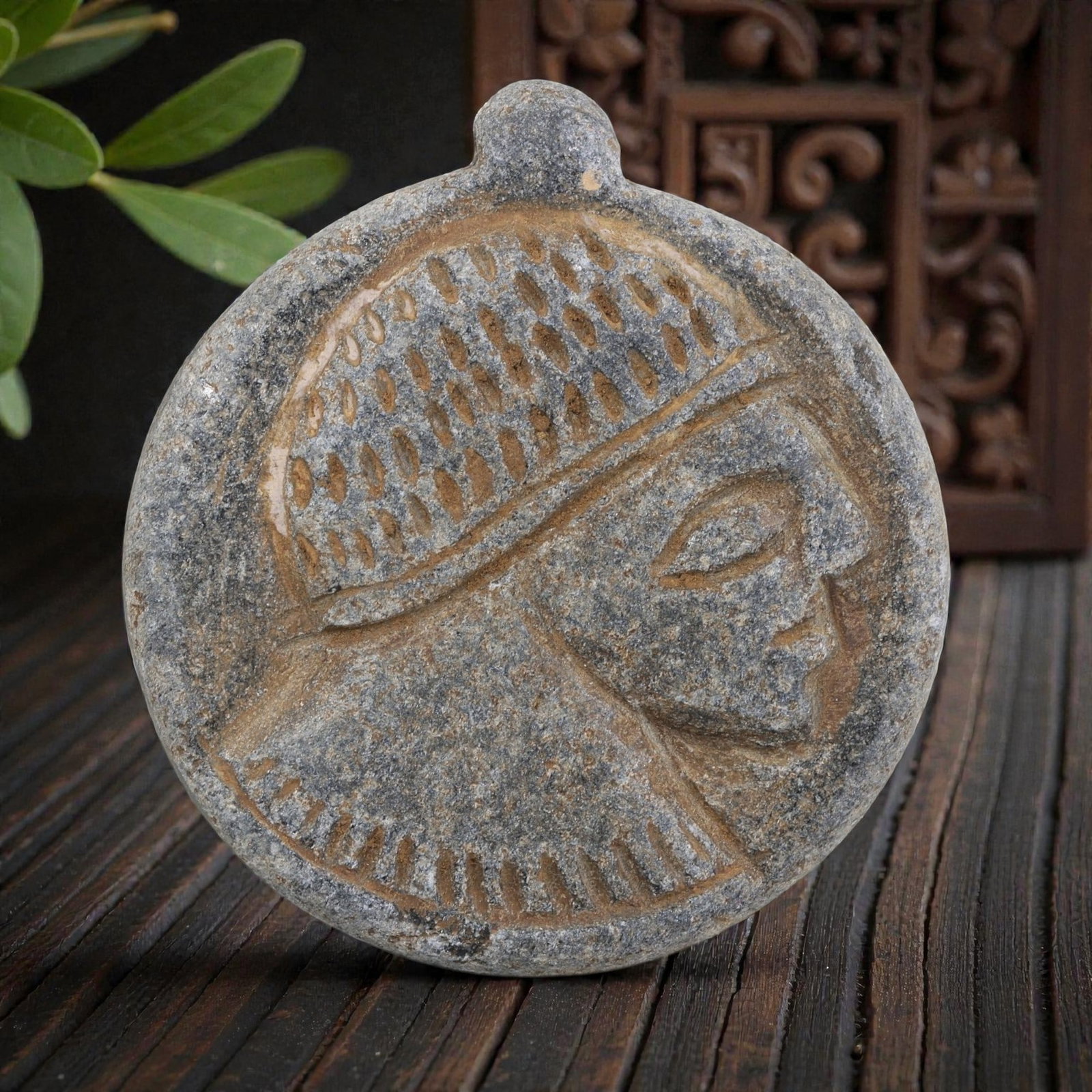 Antique Medieval Islamic Carved Stone Amulet with Profile Head Motif, 91AN: Crafted from weathered grey stone with earthy patina, this circular amulet features a deeply incised profile of a human head, characteristic of medieval Islamic decorative traditions. The figure wears