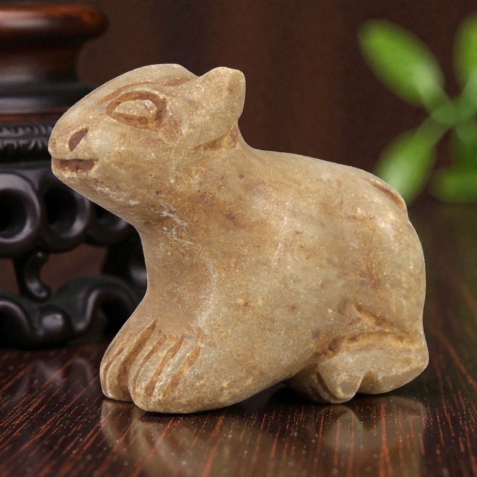 Ancient Stone Feline Amulet - Egyptian Figurine, 88AL: Carved from tan speckled stone, this amulet depicts a crouching feline, likely a cat or lion cub, with stylized incised facial features including almond-shaped eyes, a small nose, and a gently curved 