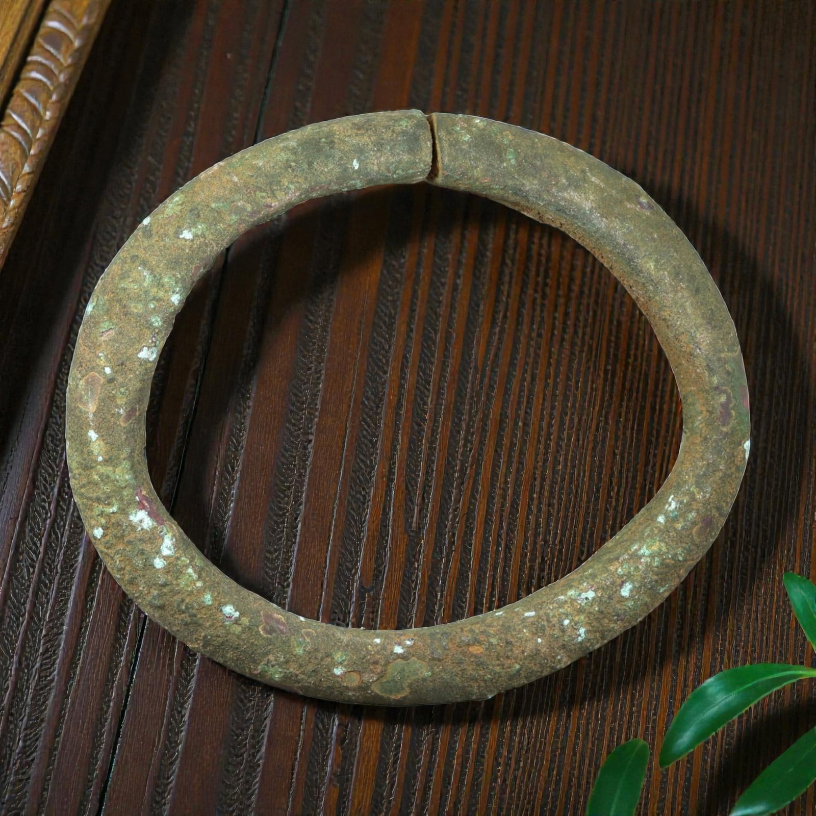Ancient Bronze Bracelet - Roman Split Bangle, 39BN: A near-continuous bracelet crafted from cast bronze, with a rounded cross-section and a small opening at the top. The simple form is characteristic of utilitarian Roman provincial jewelry, designed fo
