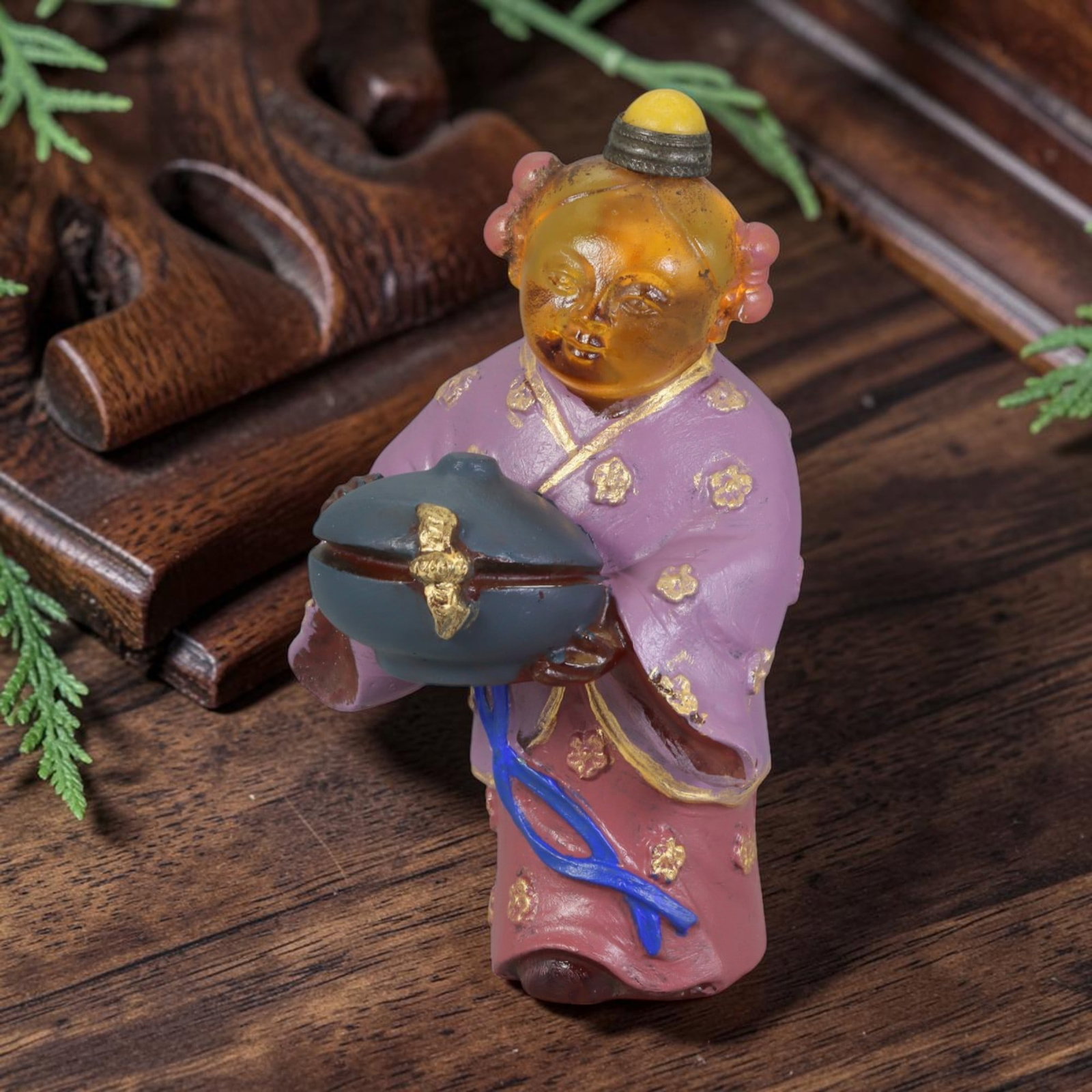 Vintage Chinese Liuli Glass Snuff Bottle - Child Holding Treasure Censer, 50AS: This snuff bottle is moulded from translucent amber liuli glass, formed as a standing child holding a covered censer with gilded ornament. The traditional robe is decorated with hand-painted gold flor