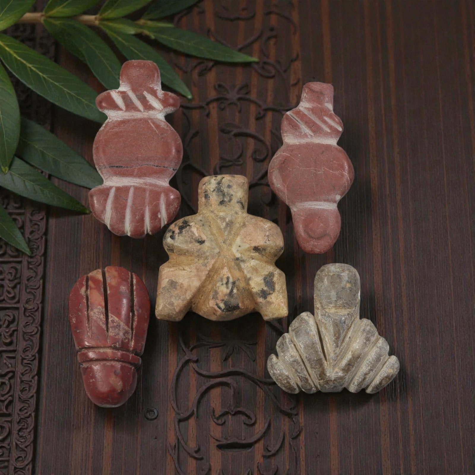 Lot of 5 Ancient Coptic Egyptian Stone Amulets, Circa Roman to Coptic Era, 47AE: The group comprises five carved stone amulets of varied stylized forms, including hand, fly, and geometric types. Three examples are worked in reddish stone, one in mottled beige stone, and one in gre