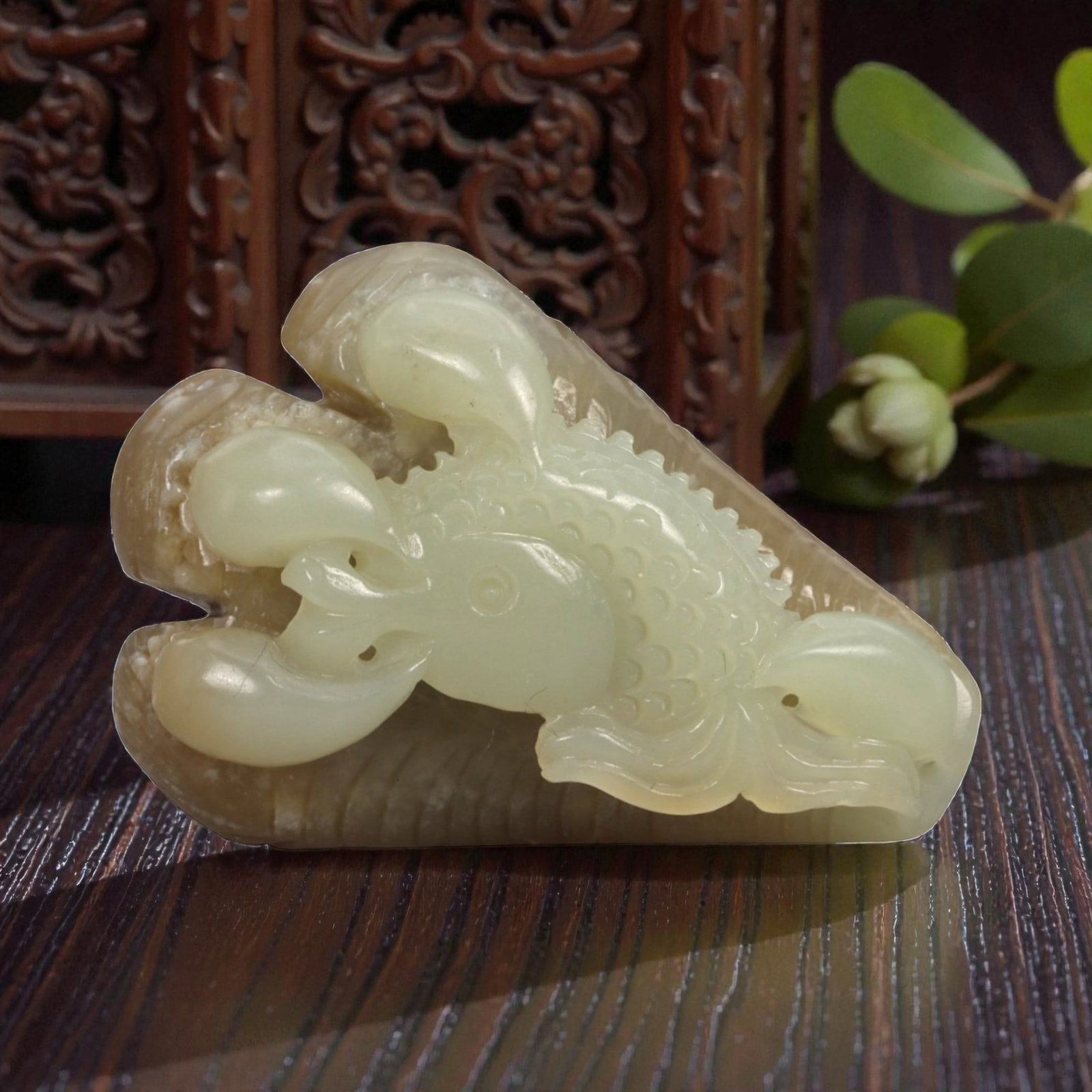 Natural XinJiang Hetian Nephrite Jade Claw with Fish Carving, 1FB: Carved from bi-colored jade with a creamy pale green body contrasted by a warm brown outer skin, the object is worked in the round as a stylized claw grasping a fish. The claw is rendered with three c