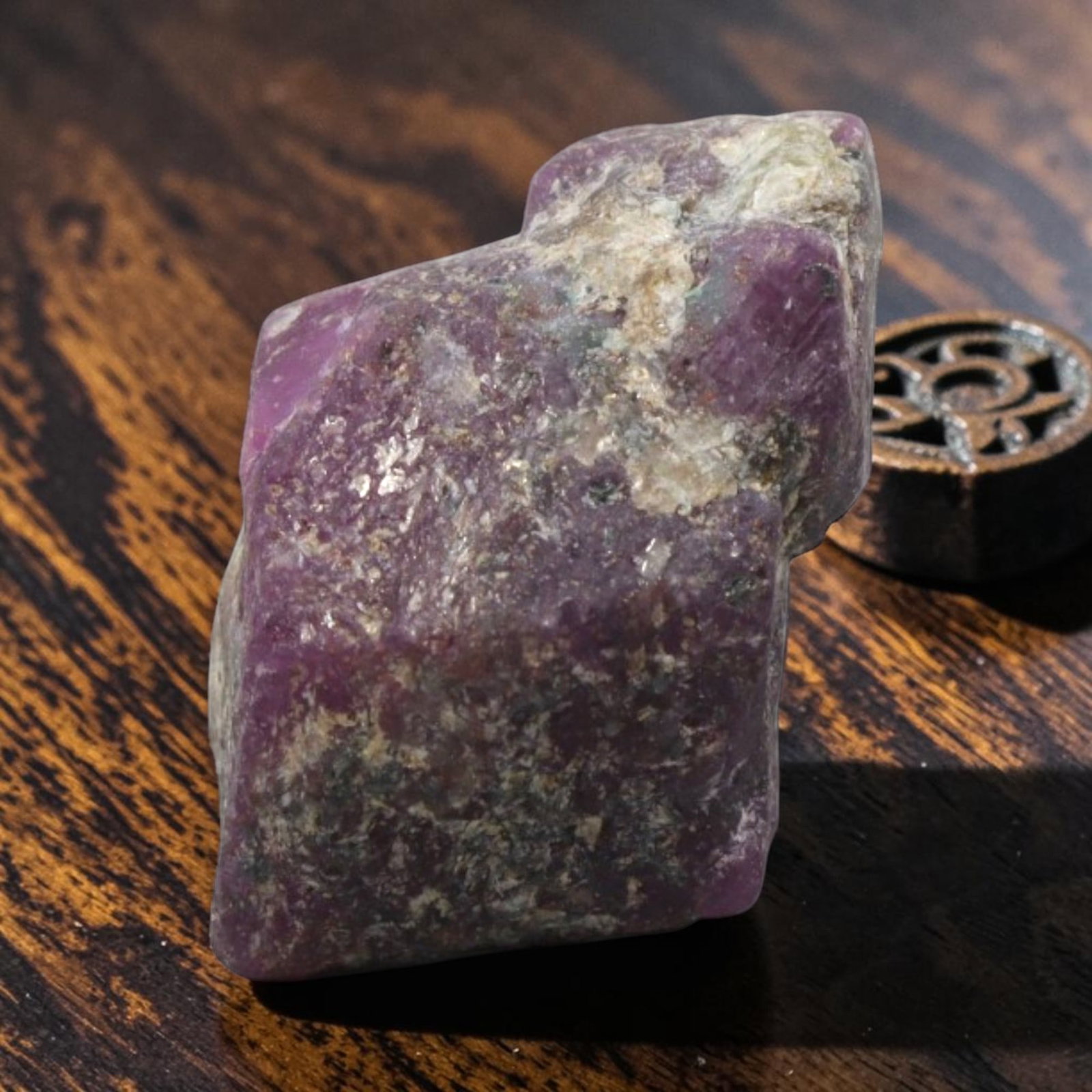 19.34ct Natural Mauritania Ruby Rough (Unheated), 83XE: This unheated Mauritania ruby rough is a captivating natural crystal specimen, featuring vivid magenta-purple ruby formations embedded in a contrasting greyish matrix. The stone's rugged, unpolished s
