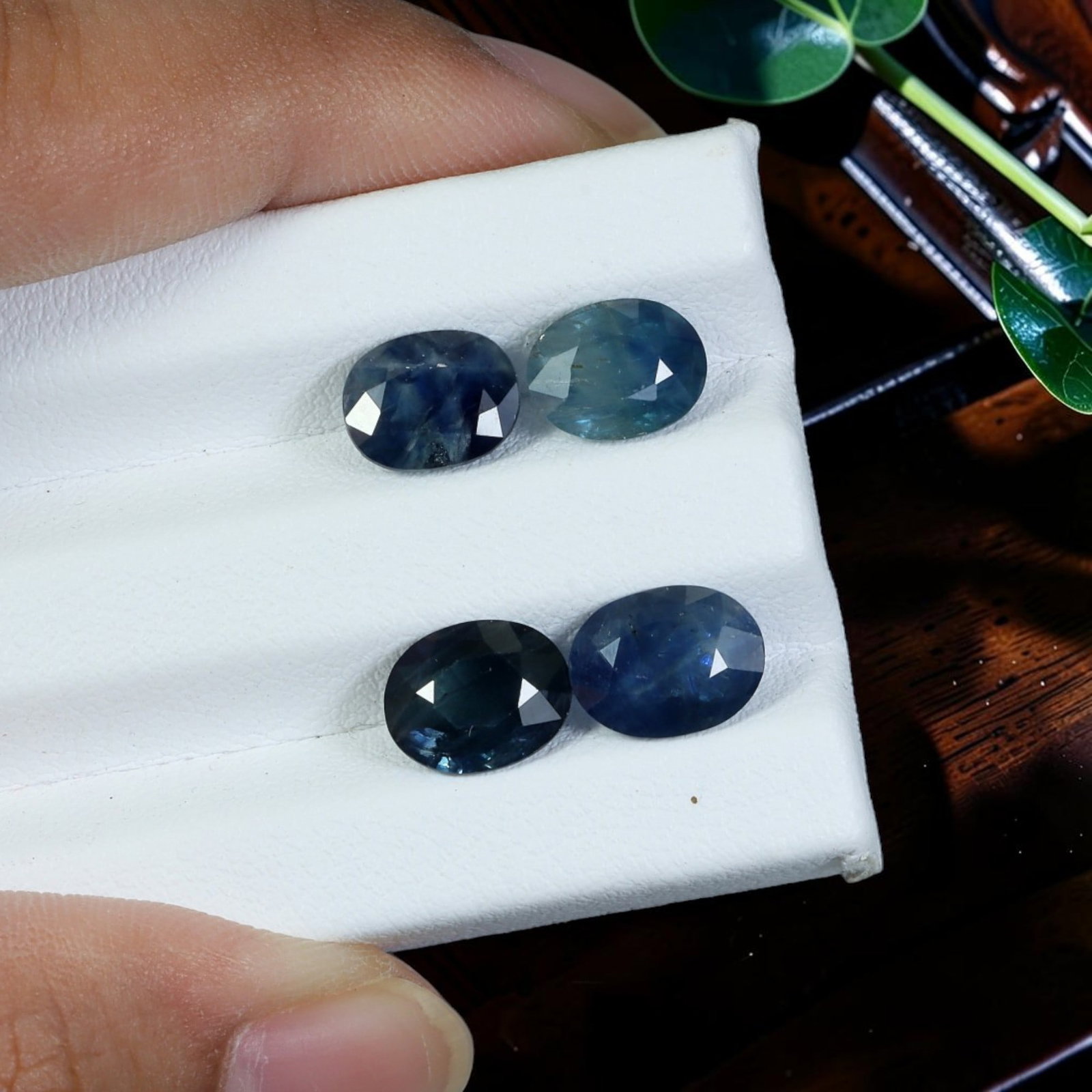 8.08 Carats Natural Oval Cut Blue Sapphire Matching Parcel, 93WC: This matched parcel contains four expertly faceted natural blue sapphires, exhibiting rich gradient navy to medium steel-blue hues with subtle natural color zoning typical of unheated sapphire rough. 