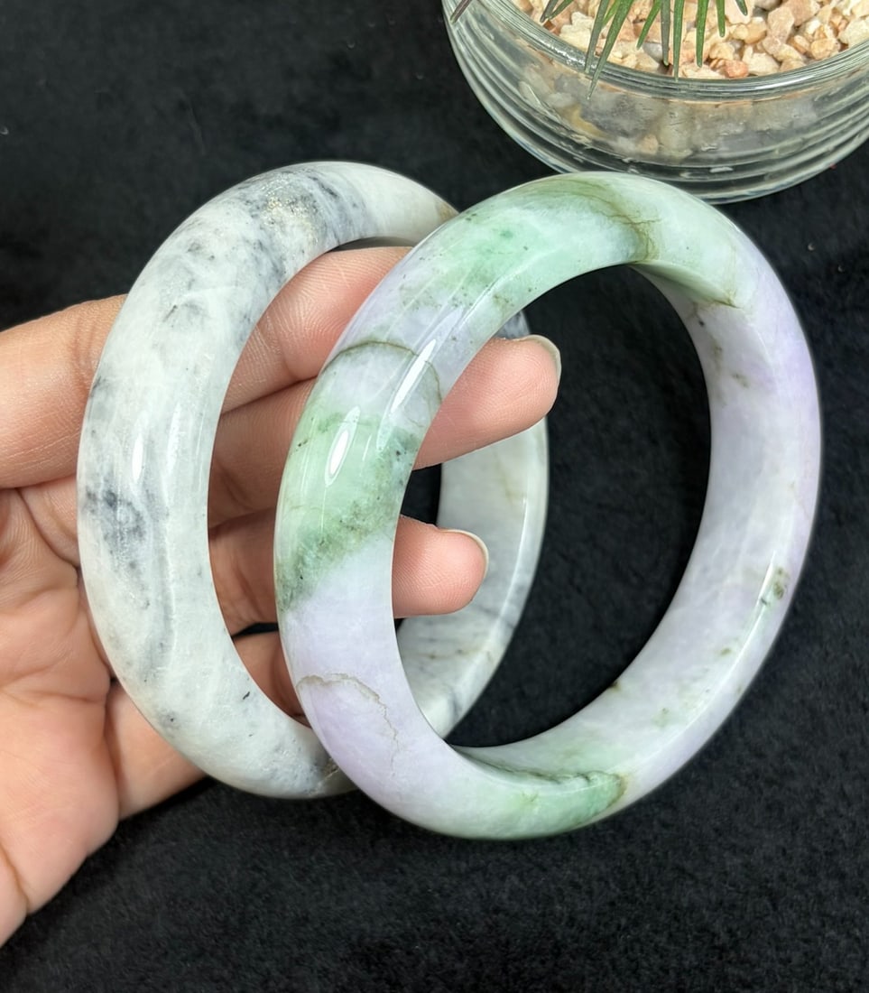 Lot of 2 Natural Burmese Type A Jadeite Bangles, 58.1mm & 61.8mm, 41AV: Two untreated genuine Type A jadeite bangles sized 58.1mm and 61.8mm inner diameter; one white base with natural dark ink cloud veining, the other soft lavender jade with vibrant floating green moss s