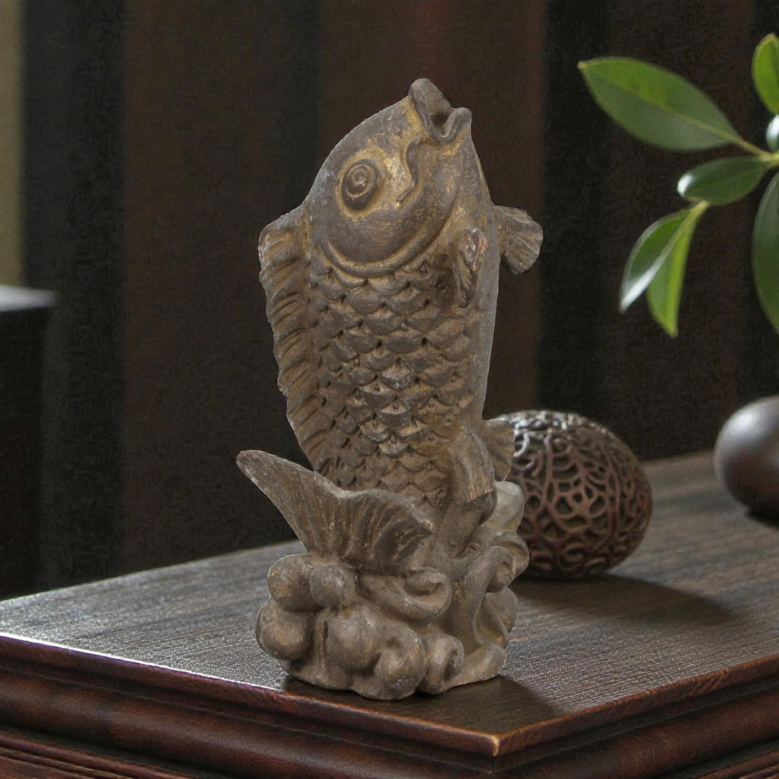 Old Chinese Bronze Fish Sculpture, Late Qing Dynasty, 19FH: Cast in bronze, the sculpture is formed as a single fish shown upright, emerging from stylized waves that serve as an integral base. The fish is rendered with a rounded head, prominent circular eye, a