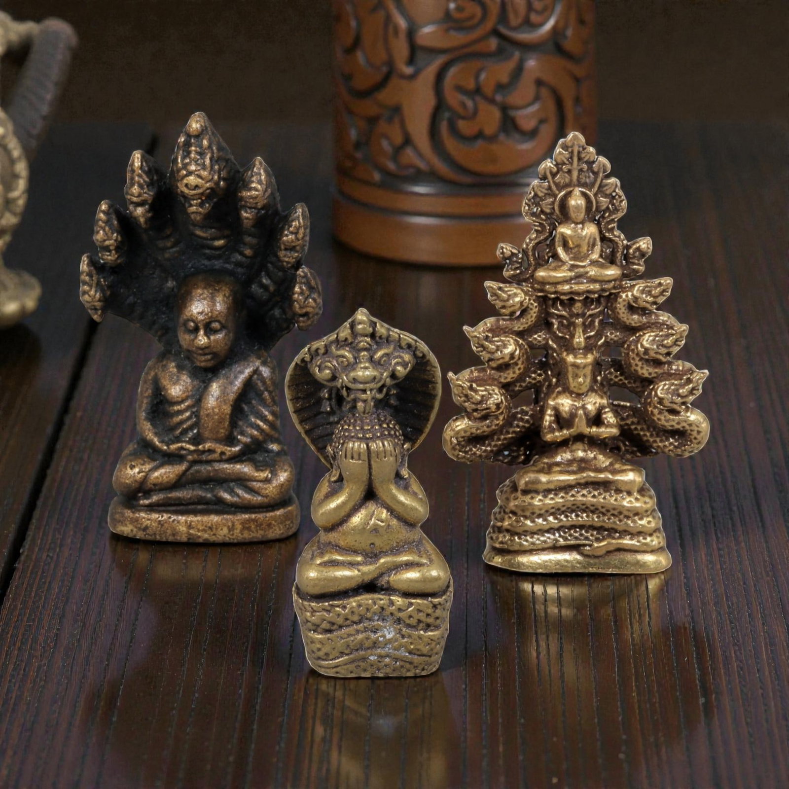 Thai Vintage Copper Alloy Naga-Protected Buddha Devotional Figures - 3pcs Set, 97ZB: This set of three devotional figures is crafted from copper alloy, exhibiting a warm aged patina and fine surface wear consistent with vintage Thai folk religious art. The pieces depict Buddha figures
