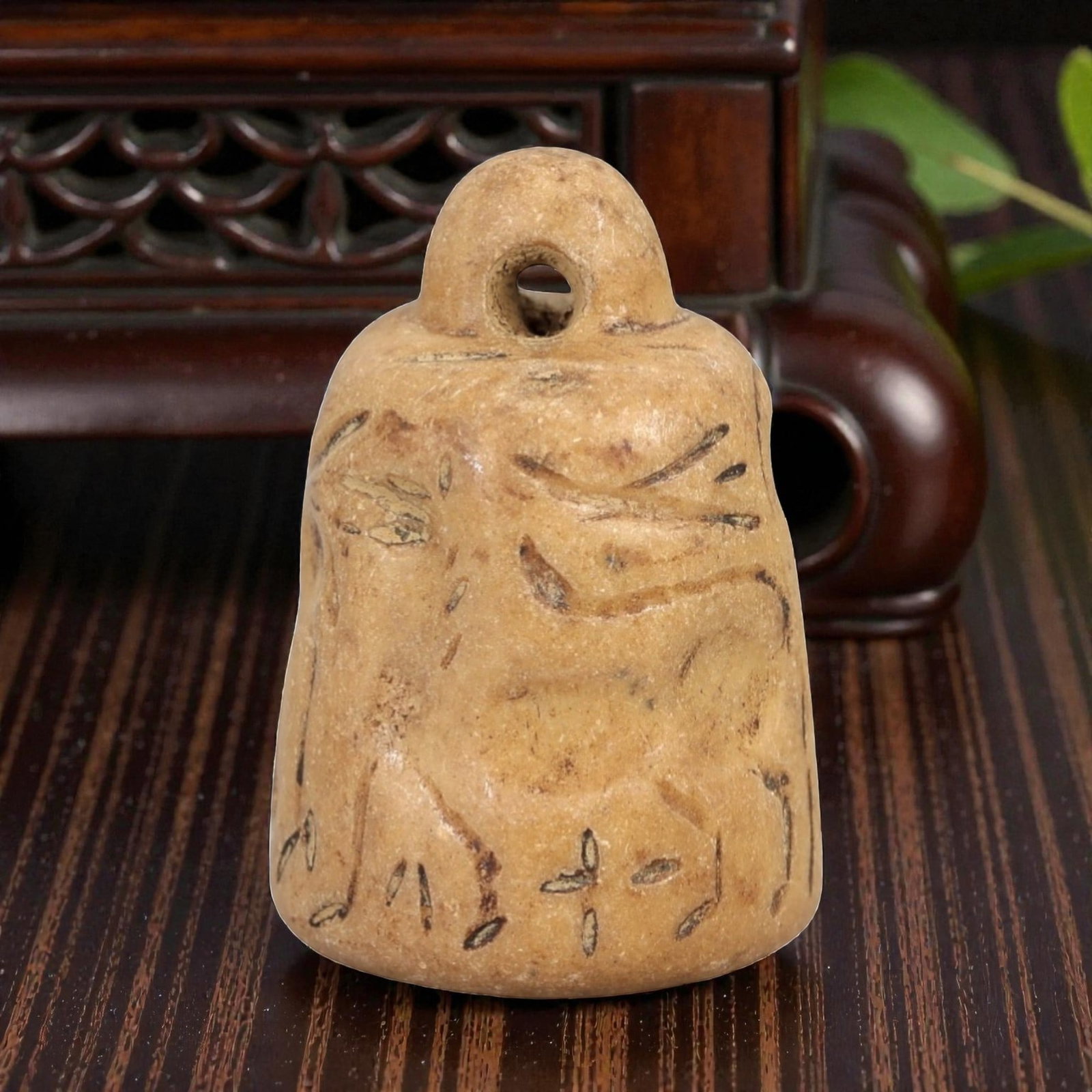 Ancient Bell-Shaped Stone Stamp Seal - Near Eastern Zoomorphic Impression, 33AM: This bell-shaped stamp seal is carved from a pale, granular stone with a warm earthy patina, exhibiting subtle surface striations and natural mineral inclusions. The form features a rounded, pierced s