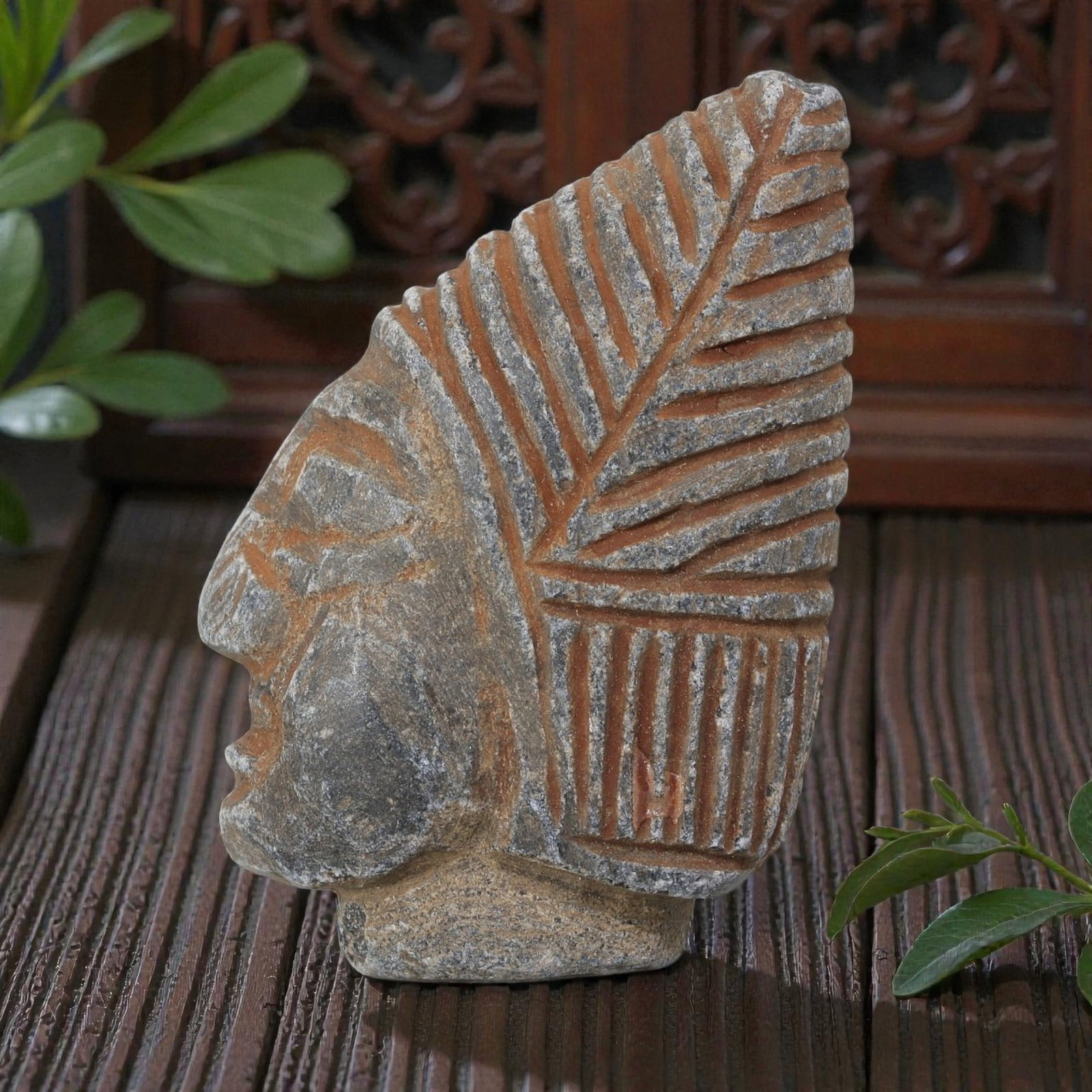 Antique Islamic Carved Stone Head, 92AN: Carved from grey stone with reddish pigment in the incised details, this artifact depicts a stylized human head in profile. The figure features simplified facial features, with a headdress or hairstyl