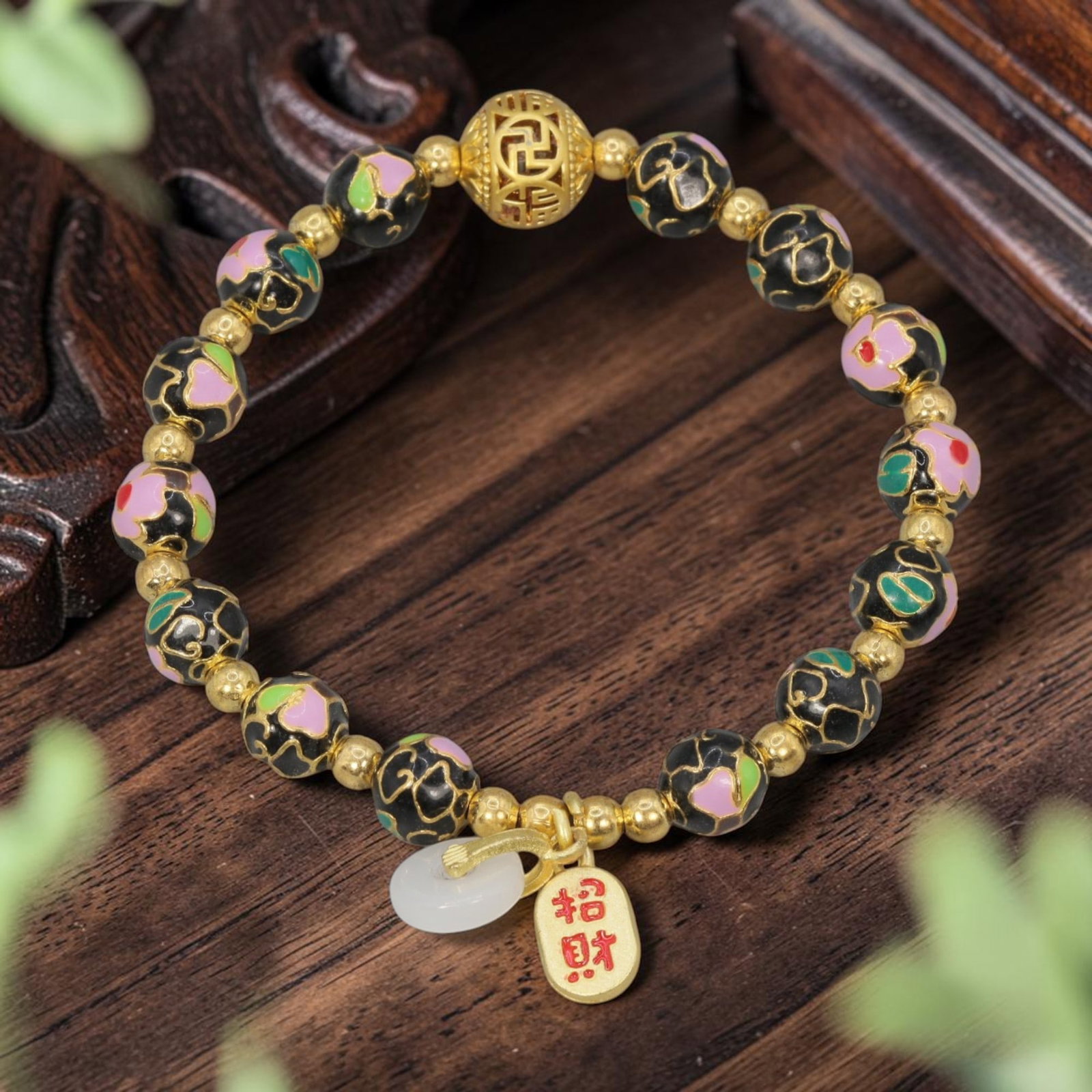 A Chinese Cloisonne Enamel Beaded Bracelet - Black Gold-Tone Wealth Charms, 47YJ: This modern Chinese-style bracelet features 10.36mm round cloisonne enamel beads in a deep black hue, each detailed with raised gold-tone floral patterns accented with pink and green enamel. Small smo