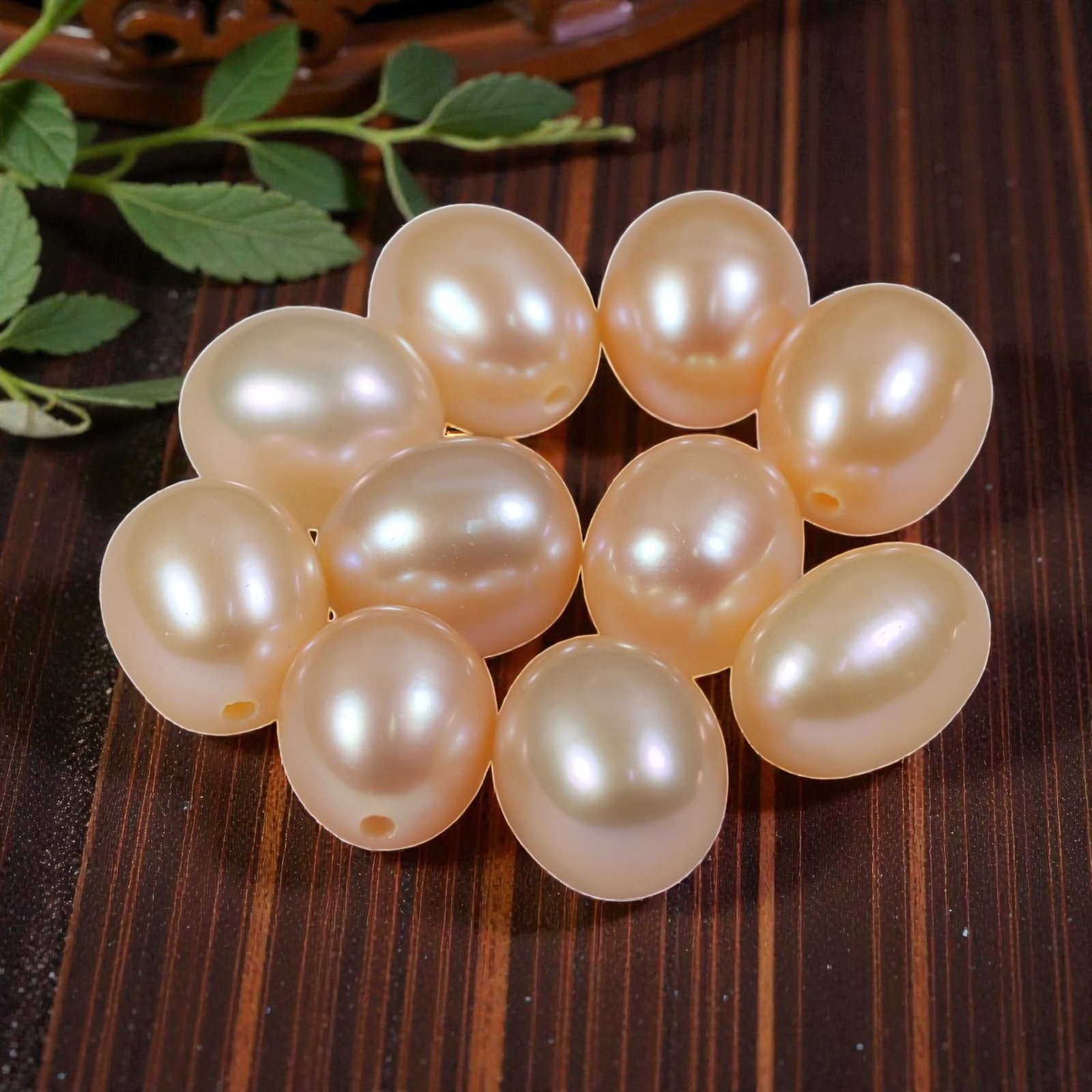 29.48ct Natural Fresh Water Pearl Drilled, 27YH: This is a drilled, natural freshwater pearl, showcasing a soft, warm peach-pink hue with a smooth, polished surface and gentle iridescence. The pearl features a classic oval shape with a consistent, e