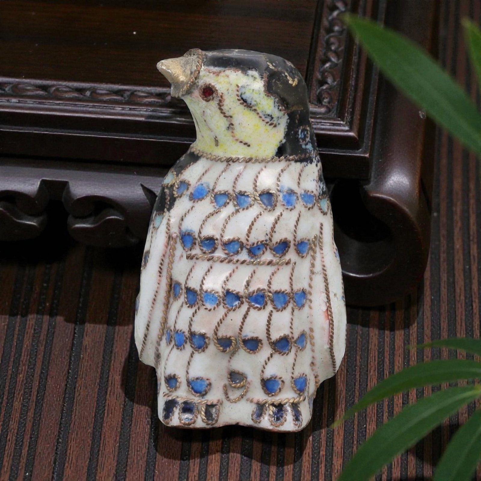 A Chinese Cloisonne Enamel Penguin Effigy, 20th Century, 96FG: Constructed from a copper alloy body and decorated with cloisonne enamel, the object is formed as a standing penguin with an upright posture and the head turned slightly upward. Fine metal wire cloiso