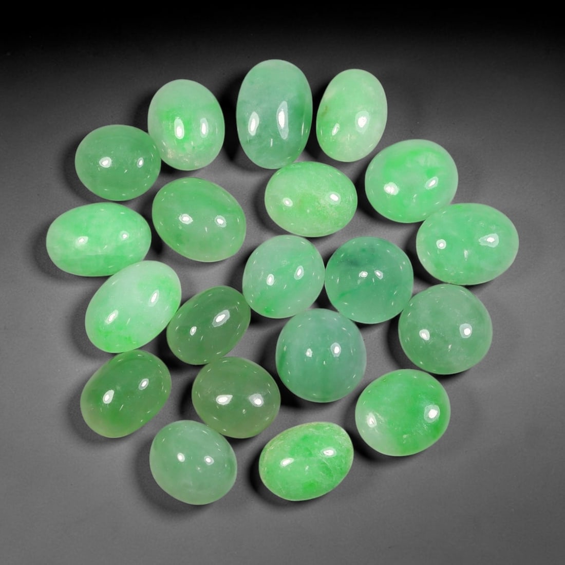 Lot of 20pcs 95.7ct Natural Burmese Type A Soft Apple Green Jadeite Jade Cabochons, 66AV: This wholesale bulk set includes 20 fully untreated natural Burmese Type A jadeite jade oval cabochons with a total combined weight of 95.7ct, uniform dimension 14x10mm. Each stone features a transluc