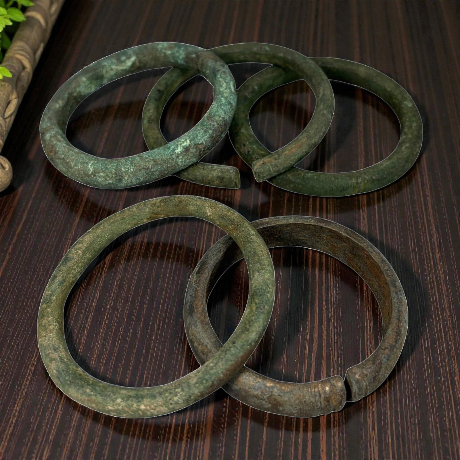 Lot of 5 Roman Bronze Bracelets, Circa 1st-4th Century CE, 89AG: A group of five open-ended bracelets crafted from bronze, exhibiting rich green patination with lighter verdigris deposits and areas of darker oxidation, consistent with archaeological age. The bracel