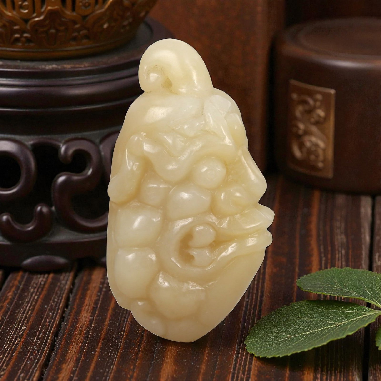 A Chinese Jade Anthropomorphic Head Carving, 20th Century, 34FA: Carved from pale yellow jade with a creamy, semi-translucent appearance and subtle tonal variation, the object represents an anthropomorphic head rendered in relief and partial three-dimensional form.