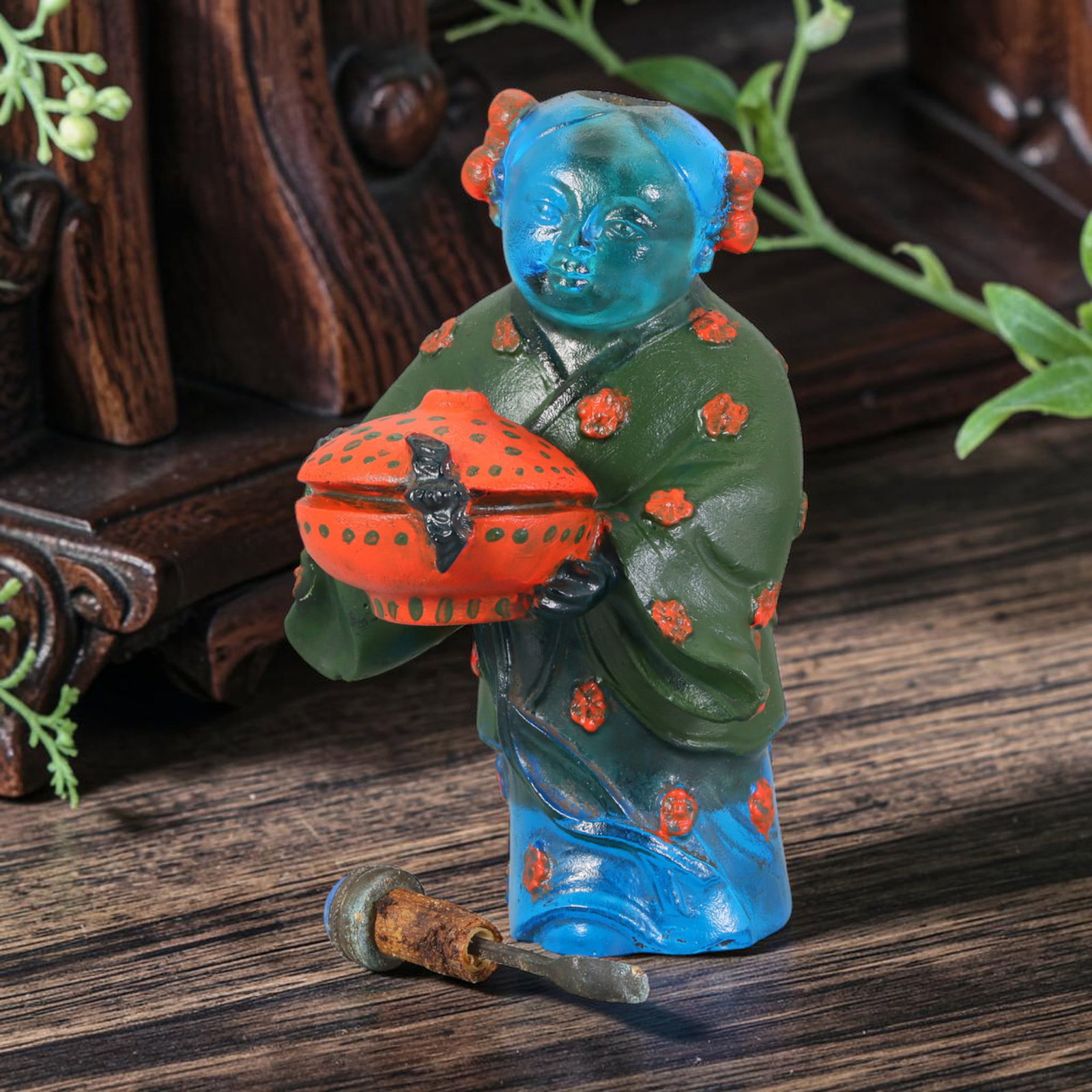 Vintage Chinese Liuli Glass Snuff Bottle - Girl Holding Censer, 29AS: This snuff bottle is cast from translucent blue liuli glass, shaped as a young girl holding a covered censer with bat ornament. The traditional robe is decorated with hand-painted red floral motifs an