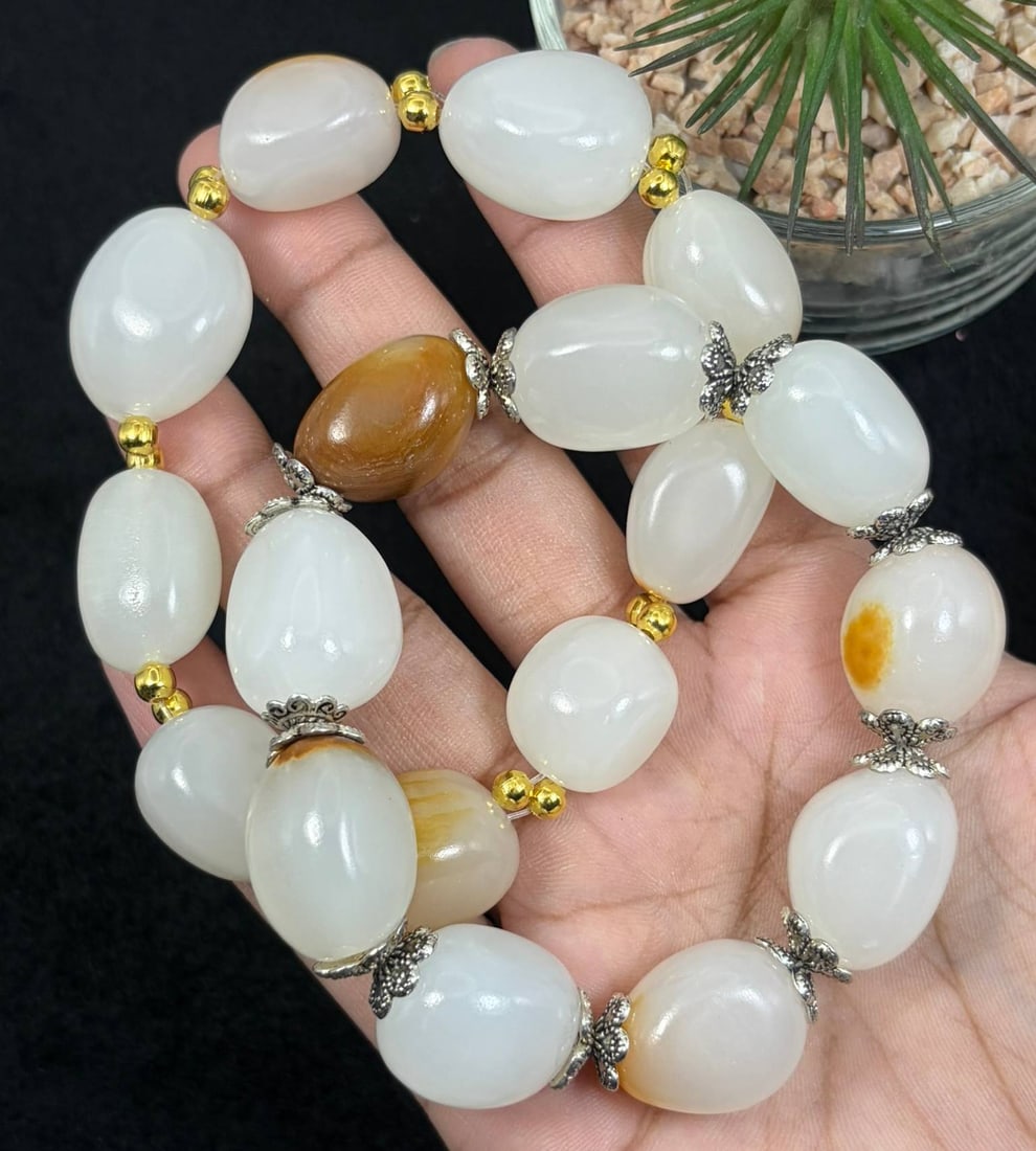 Lot of 2 Natural White Hetian Nephrite Seed Jade Bracelets, 6AS: Set of 2 hand-strung stretch bracelets made of polished natural white Hetian nephrite river seed jade pebbles, with the largest oval jade beads measuring 2.2cm. Smooth milky white jade features natura
