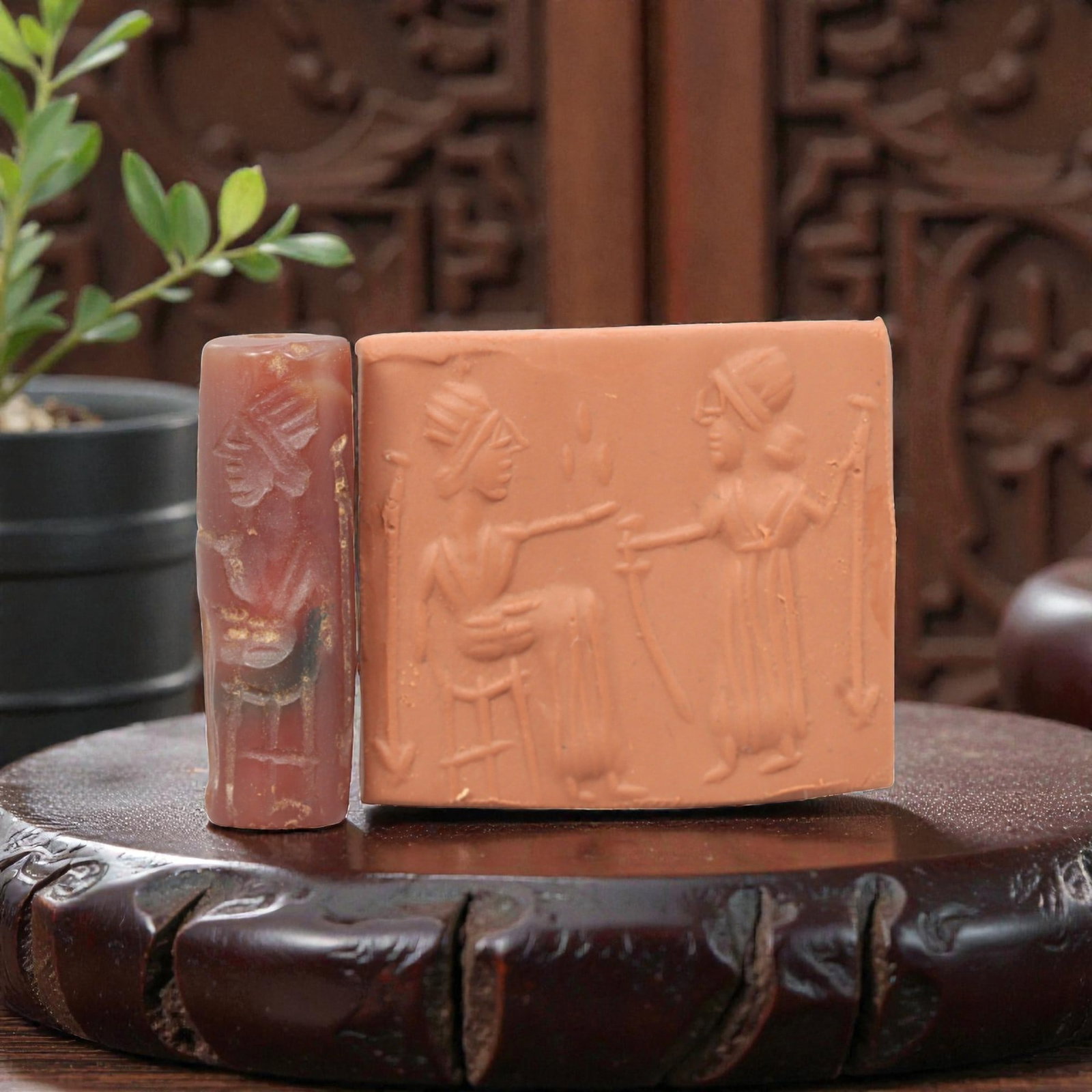 Ancient Carnelian Cylinder Seal - Mesopotamian Figural Ritual Scene, 73ZS: Carved from richly hued carnelian, this ancient Mesopotamian cylinder seal features a refined linear relief composition of two human figures in ritual interaction-one seated on a stool and gesturing, 