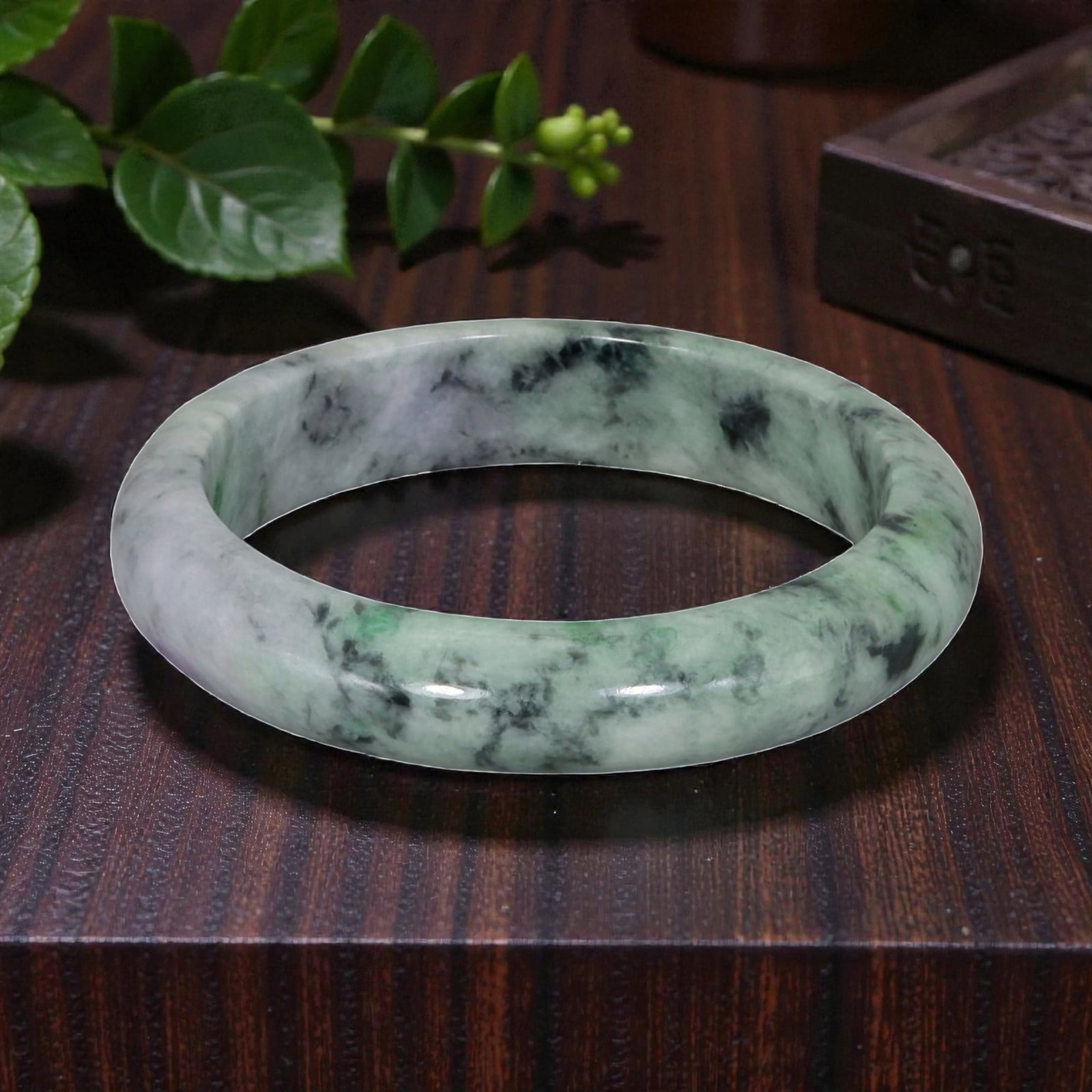 Natural Burmese Type A Green & Black Jadeite Jade Bangle - Ink Moss in Snow Bracelet, 73YH: Crafted from natural Burmese Type A jadeite jade, this bangle showcases a striking variation of the "Moss in Snow" pattern, with bold black and green inclusions creating a natural, ink-like marbled ef