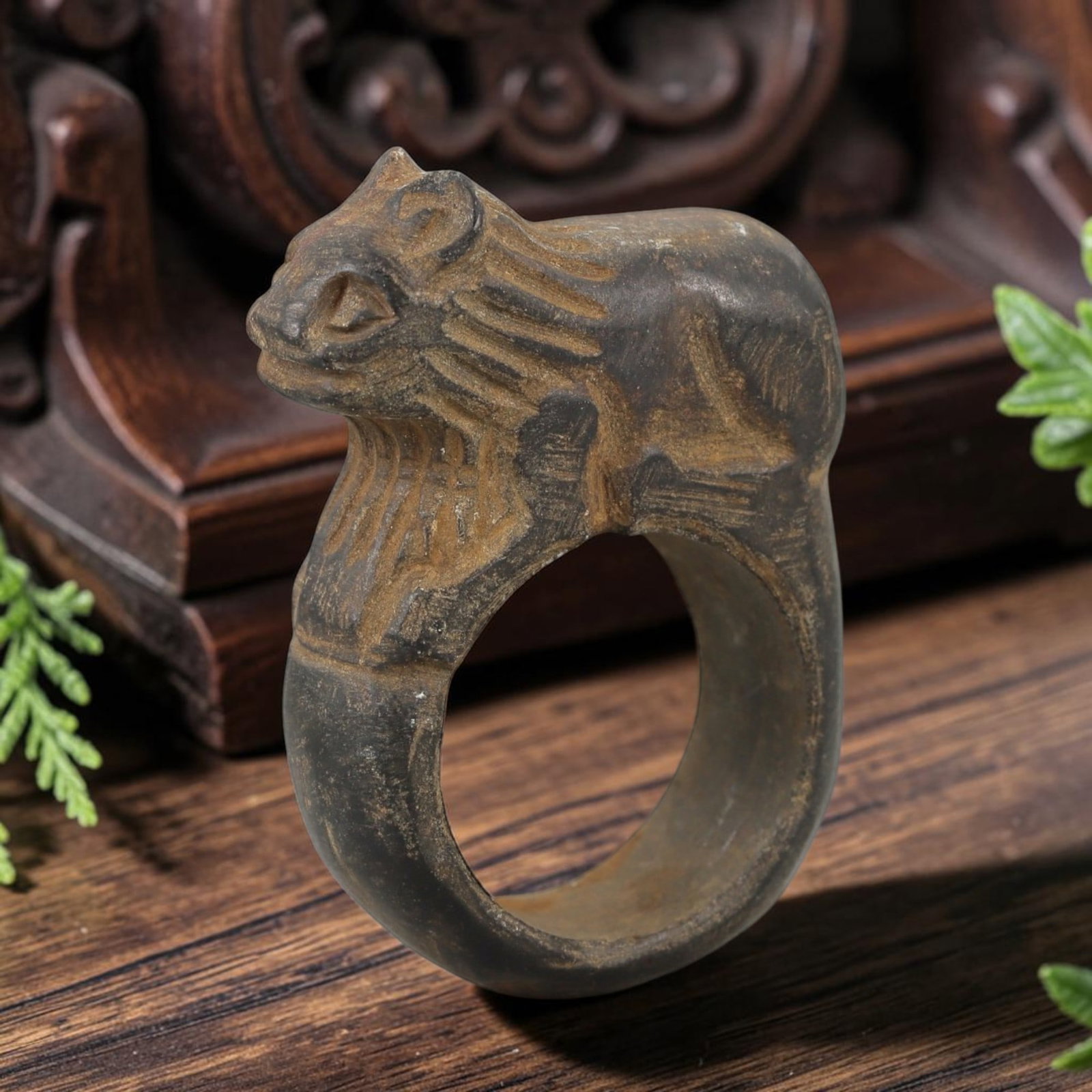 Ancient Steatite Achaemenid Ring - Zoomorphic Carving, 32AH: Crafted from steatite stone, this ancient Achaemenid ring features a zoomorphic lion-head motif with incised detailing, characteristic of Achaemenid glyptic art. The stone exhibits a natural, earthy p