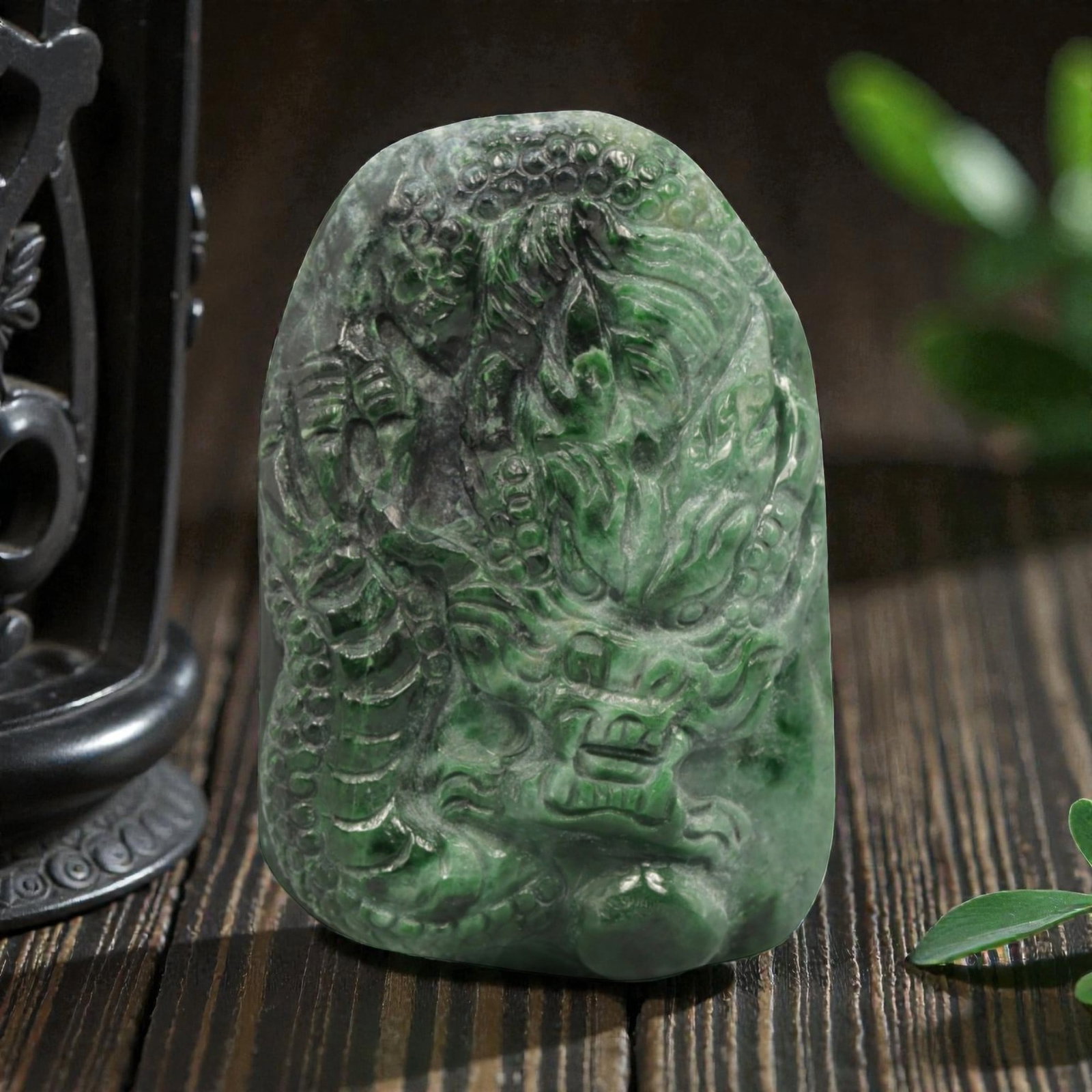 Natural Burmese Type A Jadeite Jade Pendant, 20th Century, 26ZL: Carved from green jadeite jade with natural dark green and greyish inclusions distributed throughout the matrix, the pendant is formed as an irregularly rectangular object with a relief-carved dragon 