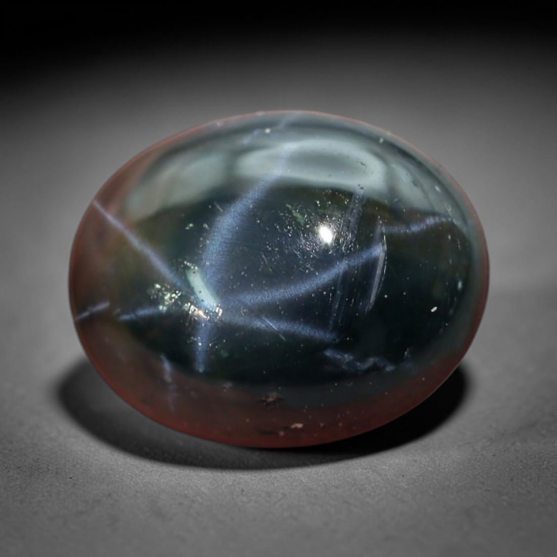 1.95 Carats Deep Midnight Star Sapphire Oval Cabochon - Natural Loose Gemstone, 2XC: This striking oval star sapphire features a rich, deep midnight blue hue that deepens to near-black at its core, creating a dramatic backdrop for its bright six-rayed star. The star's vivid, sharp ray