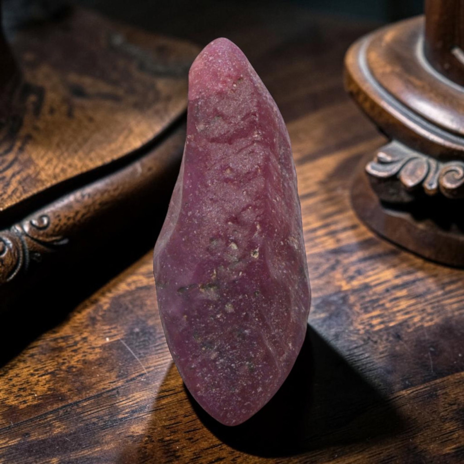12.57ct Natural Mauritania Ruby Rough (Unheated), 85XE: This unheated Mauritania ruby rough is a captivating natural crystal specimen, featuring vivid magenta-purple ruby formations embedded in a contrasting greyish matrix. The stone's rugged, unpolished s