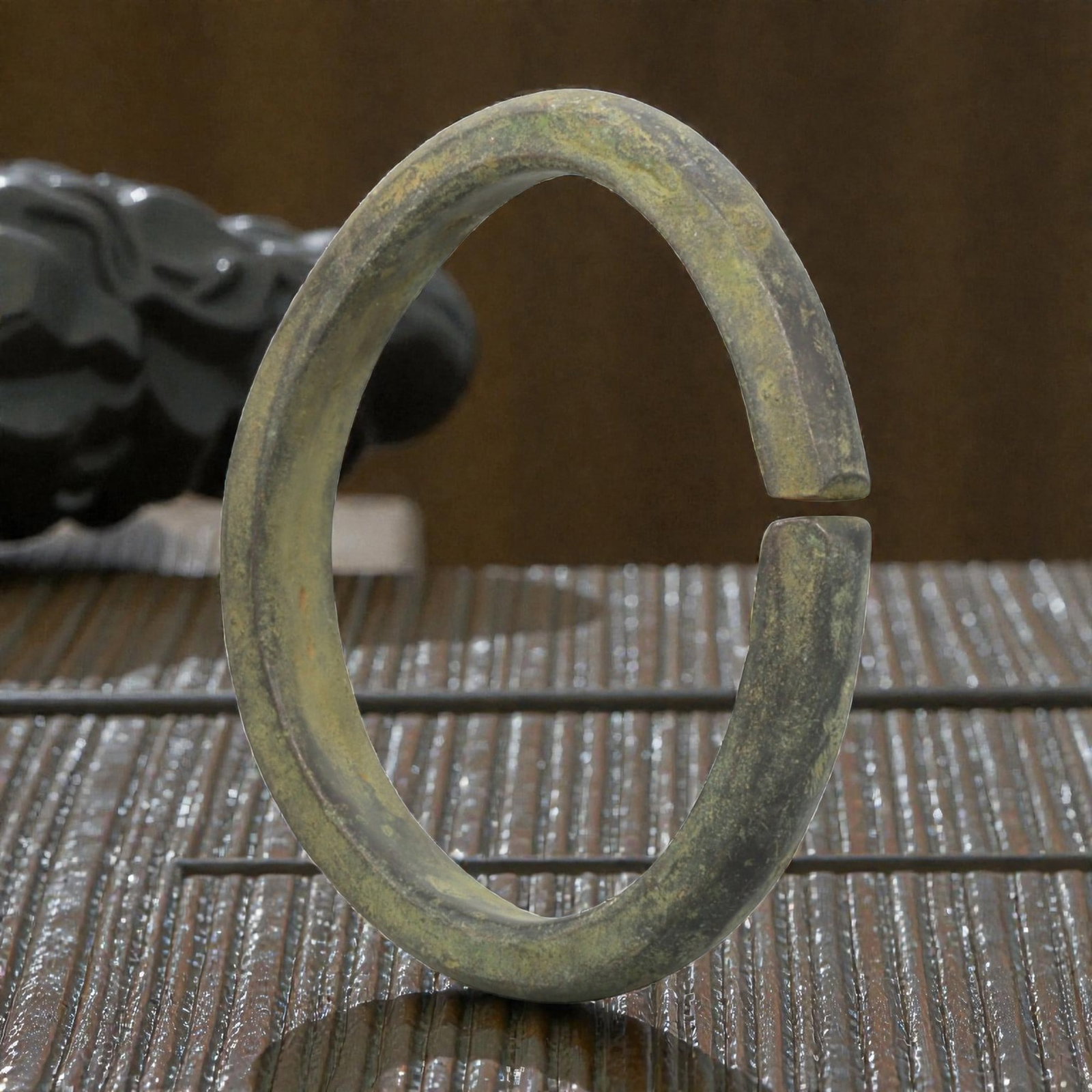 Ancient Roman Bronze Bracelet - Flat Open Form, 72BN: Crafted from bronze, this open bracelet features a thick, flat cross-section and a simple C-shaped form with a narrow gap between squared terminals. The surface displays a uniform greenish patina, ind