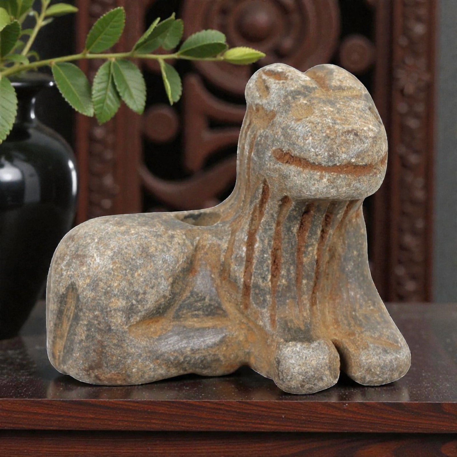 Ancient Stone Caprine Amulet - Near Eastern Animal Figurine, 41AM: This amulet is carved from speckled grey stone, depicting a stylized caprine (goat or sheep) in a recumbent, crouched posture. The piece features incised linear detailing defining the facial features,