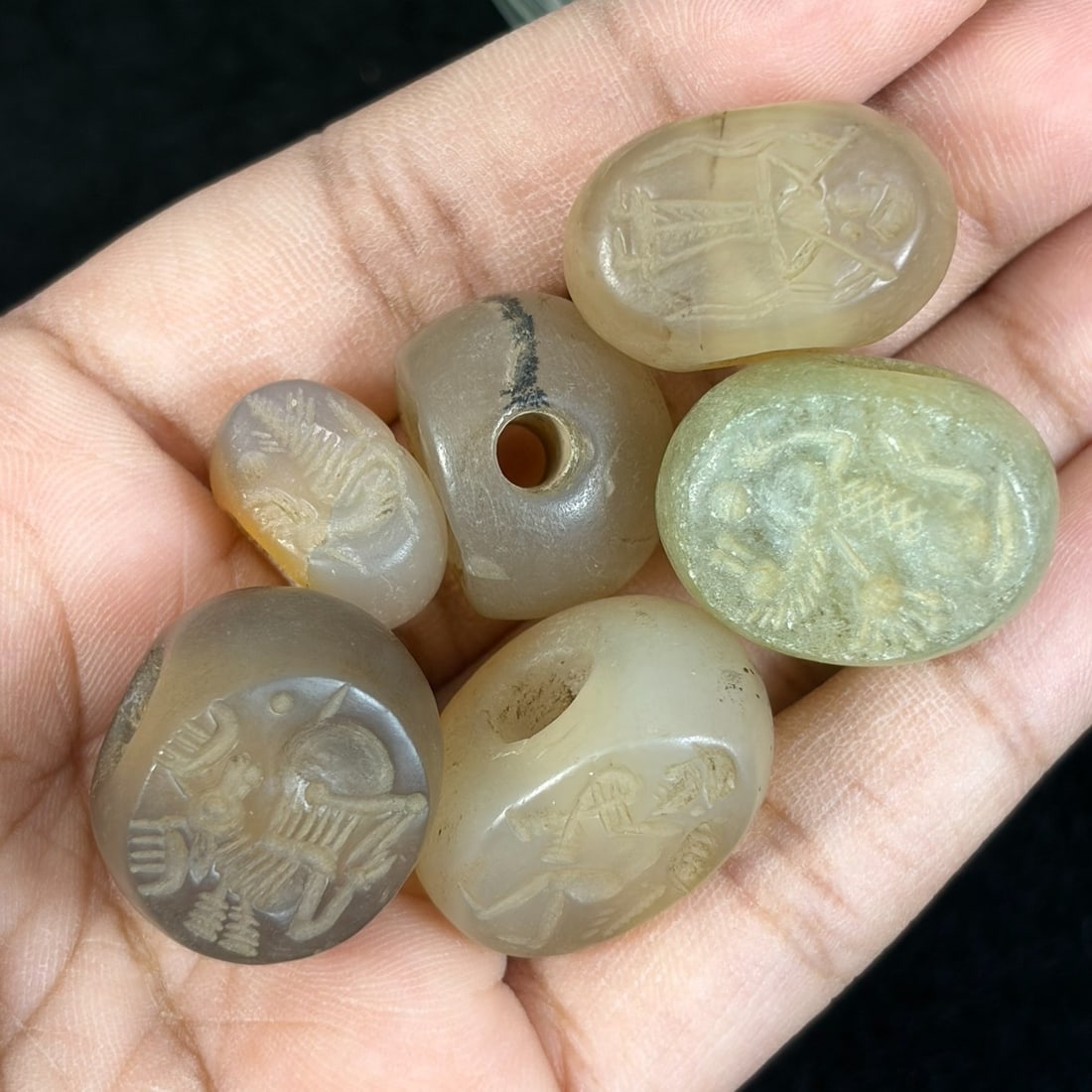 Lot of 6 Ancient Sasanian Era Chalcedony Stamp Seal Amulets, 68AR: This six-piece antiquity lot features hand-carved oval stamp seals crafted from natural translucent chalcedony in soft milky grey, pale beige and light sage green tones. Each pebble-shaped seal bears 