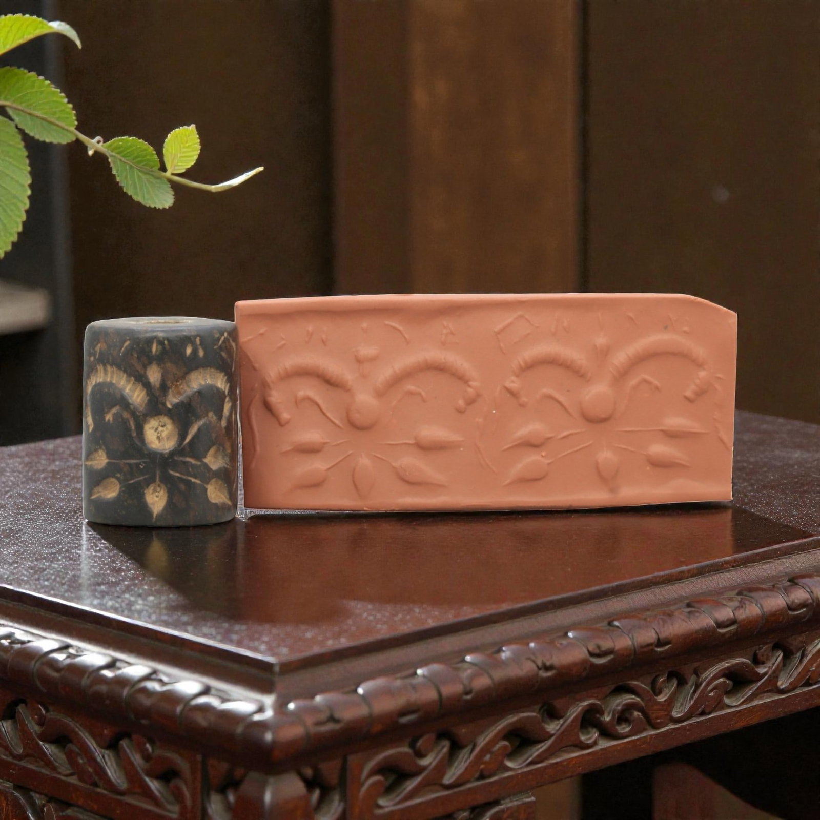 Ancient Steatite Cylinder Seal - Mesopotamian Symmetrical Botanical Motif, 97ZR: Carved from dense steatite, this ancient Mesopotamian cylinder seal features a precise symmetrical relief composition of repeated botanical and curvilinear motifs, executed in the characteristic glypt