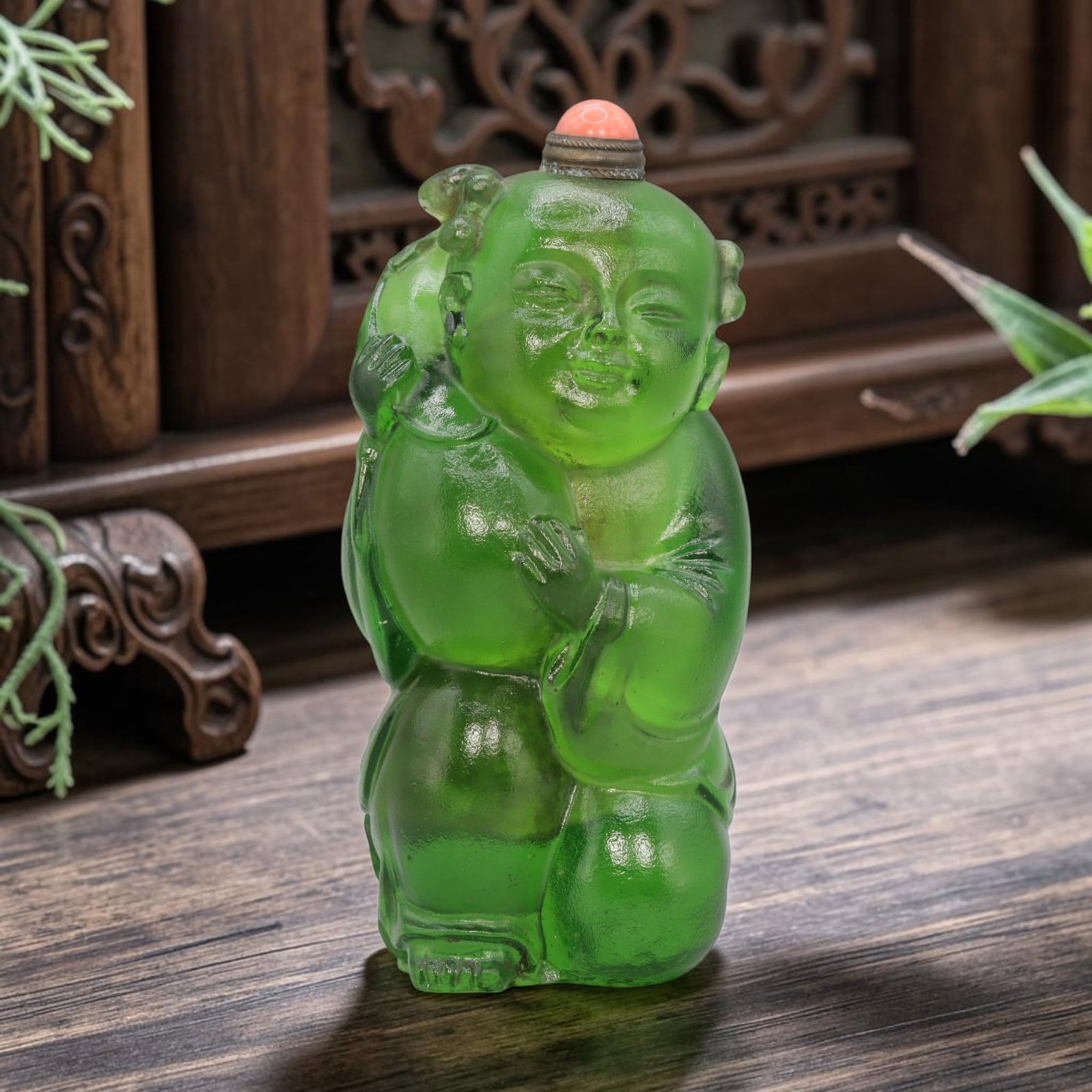 Vintage Chinese Green Liuli Glass Snuff Bottle - Child Figurine, 84YF: Crafted from translucent green liuli glass, this vintage Chinese snuff bottle is modelled as a stylized child figure holding a gourd. The glass exhibits a rich, vibrant green hue with subtle surface p
