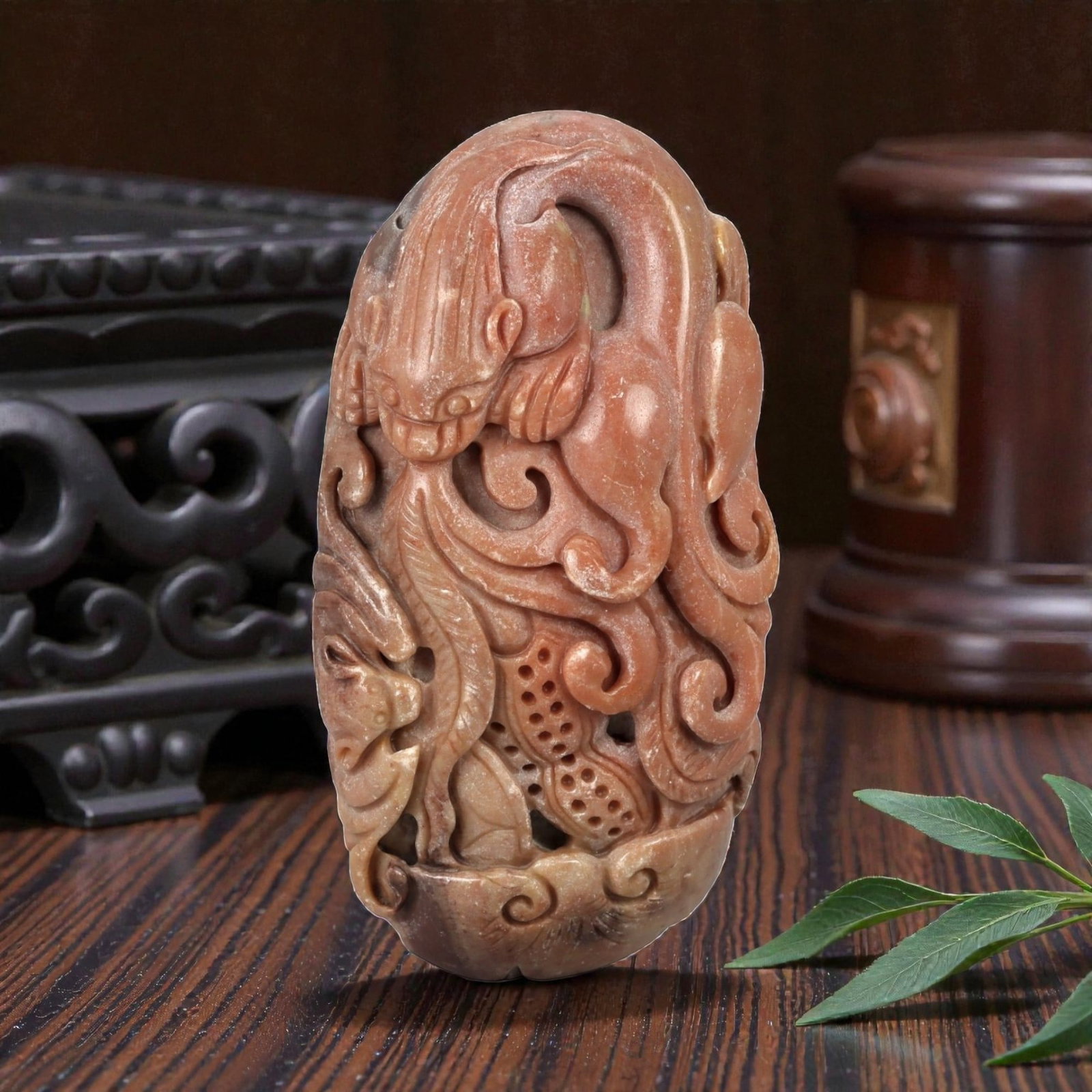 A Chinese Hardstone Carving of a Mythical Beast Pendant, 20th Century, 13FD: Carved from a dense hardstone of warm russet-brown tone with lighter inclusions, the sculpture is worked in the round as a stylized mythical beast, possibly a qilin or related zoomorphic creature. The
