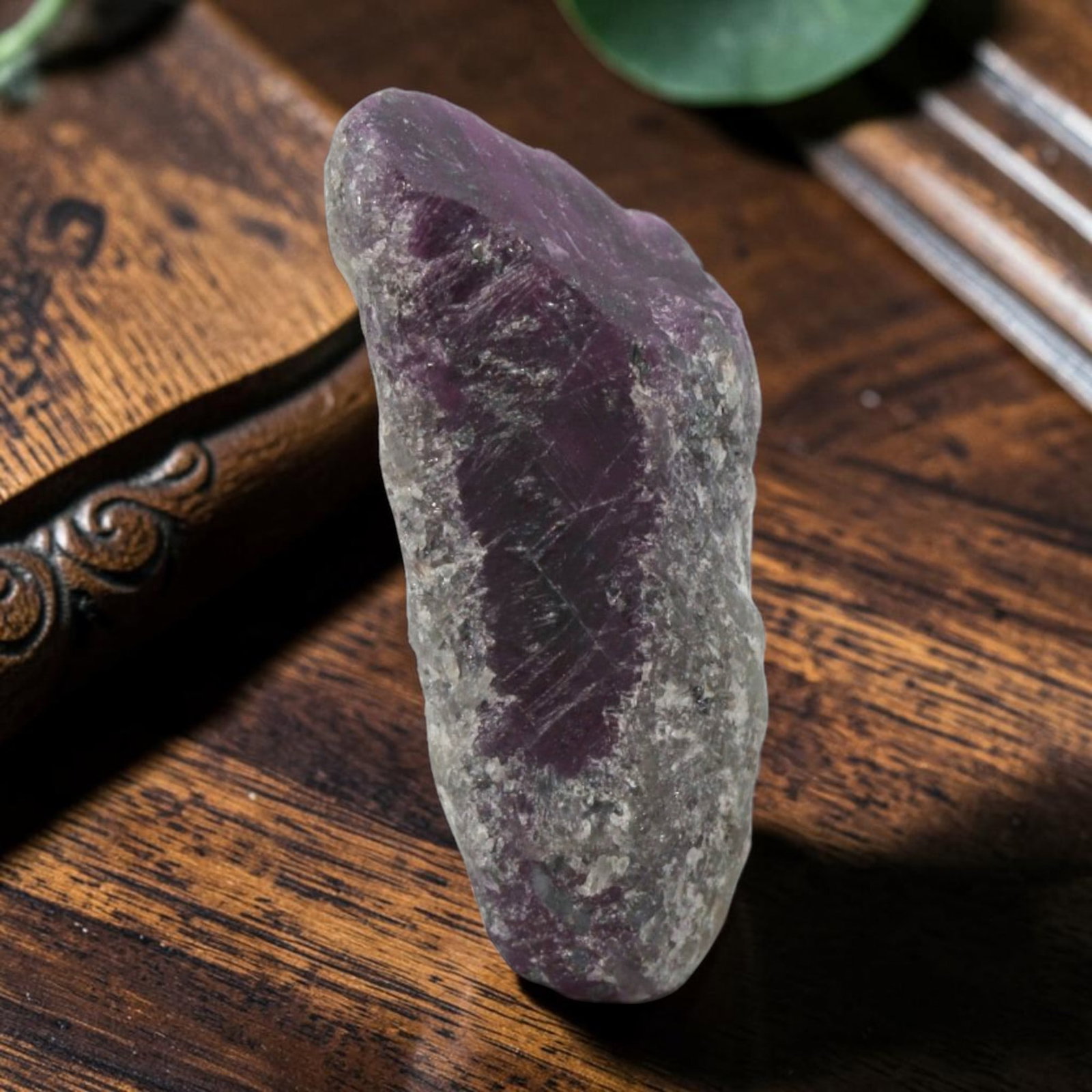14.41ct Natural Mauritania Ruby Rough (Unheated), 62XE: This unheated Mauritania ruby rough is a captivating natural crystal specimen, featuring vivid magenta-purple ruby formations embedded in a contrasting greyish matrix. The stone's rugged, unpolished s