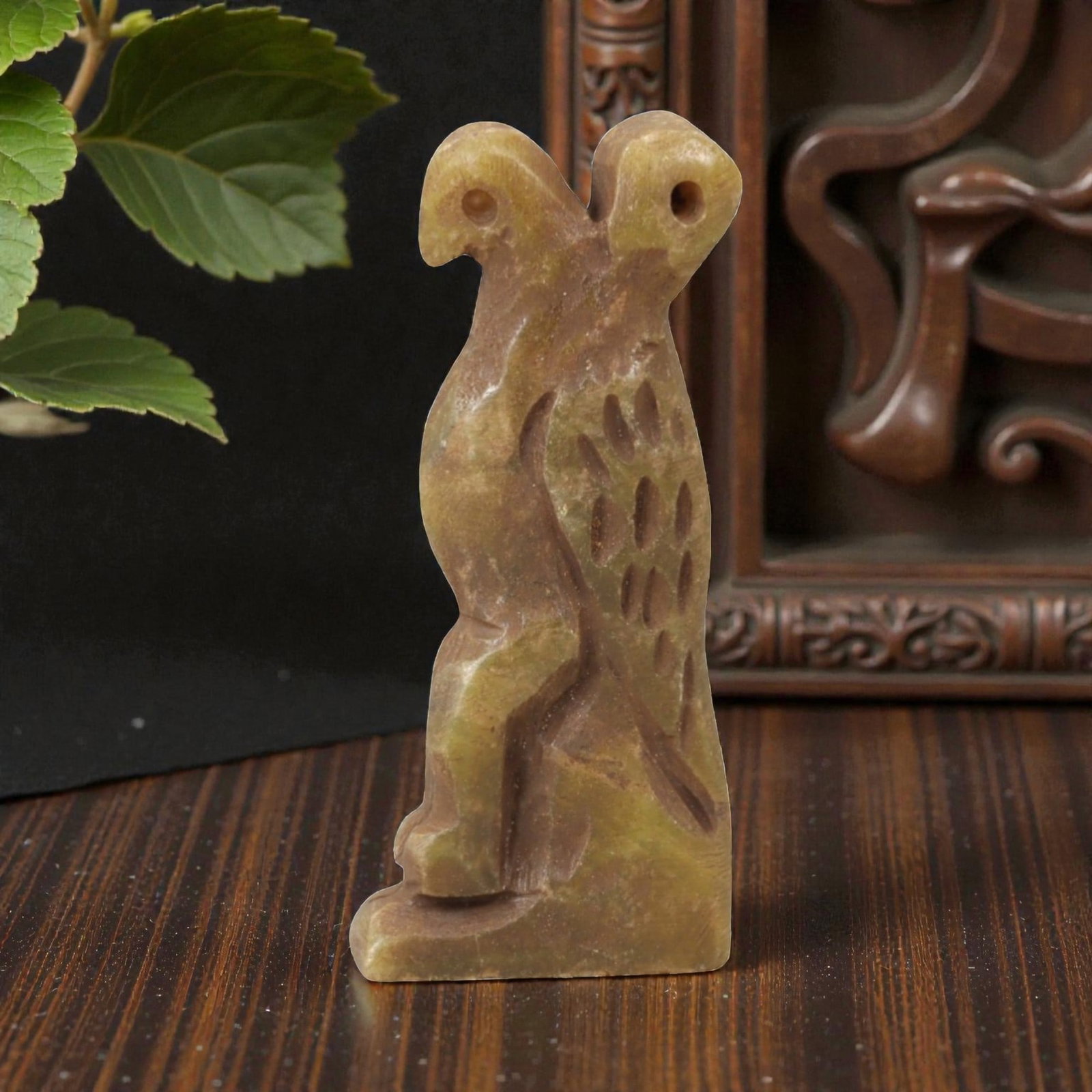 Ancient Steatite Vulture - Near Eastern Amulet Figurine, 90AK: Carved from steatite, this amulet depicts a stylized perched vulture with incised linear details defining the wing feathers, body, and facial features including a defined eye and beak, with two suspen