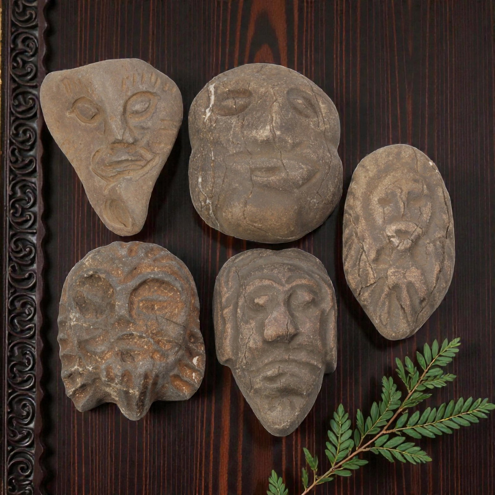 Lot of 5 Medieval Mediterranean Stone Head Carvings, 25WT: A collection of five small stone head carvings, each depicting stylized human faces worked from weathered brown stone with visible patina, surface cracks, and age-related wear. The group features vari