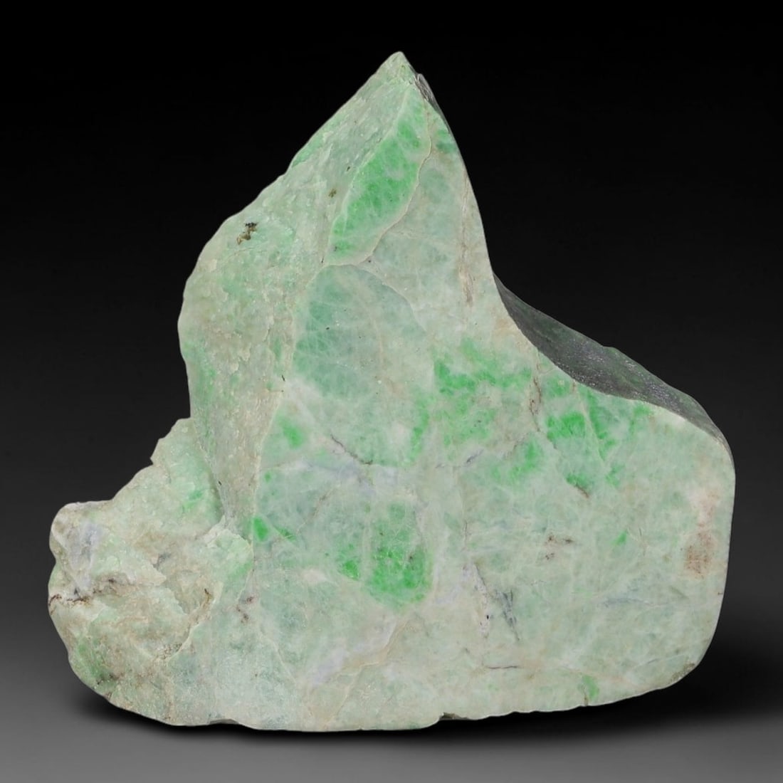 129ct Natural Type A Burmese Jadeite Jade Sliced Rough, 24AZ: This specimen is a sliced rough block of natural Type A Burmese jadeite jade. The interior displays natural colour zoning with visible mineral veining and crystalline patterns typical of unprocessed j