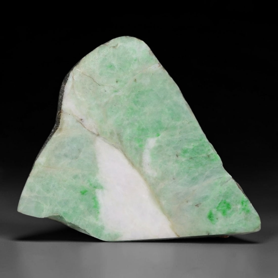 27ct Natural Type A Burmese Jadeite Jade Sliced Rough, 51AZ: This specimen is a sliced rough block of natural Type A Burmese jadeite jade. The interior displays natural colour zoning with visible mineral veining and crystalline patterns typical of unprocessed j