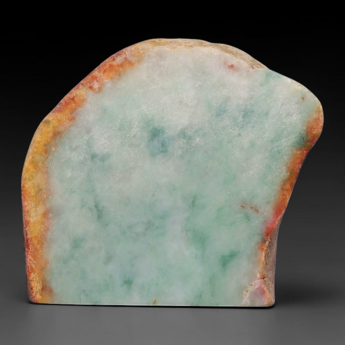 243ct Natural Type A Burmese Jadeite Jade Sliced Rough, 39AZ: This specimen is a sliced rough block of natural Type A Burmese jadeite jade. The interior displays natural colour zoning with visible mineral veining and crystalline patterns typical of unprocessed j
