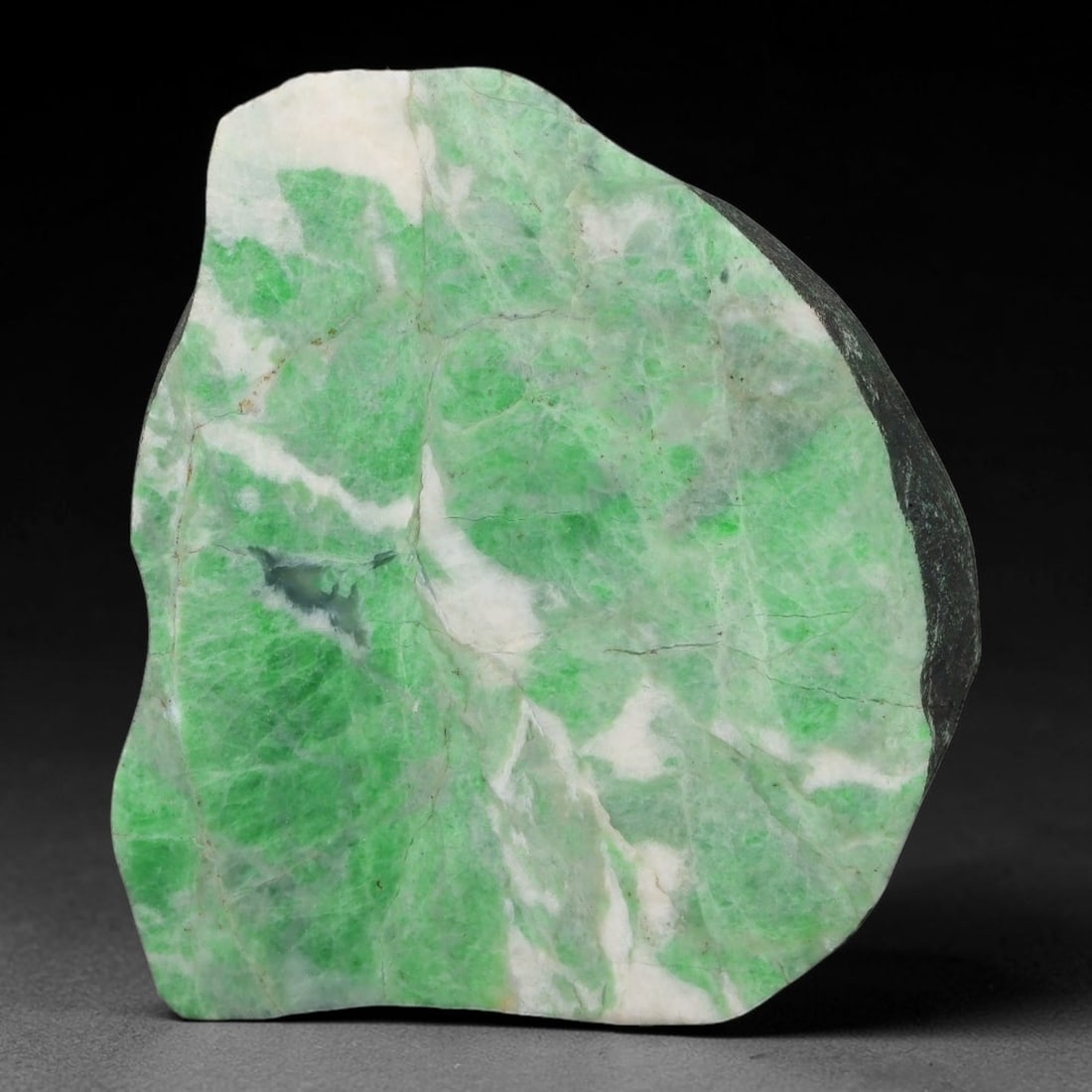 500ct Natural Type A Burmese Jadeite Jade Sliced Rough, 15YK: This specimen is a sliced rough block of natural Type A Burmese jadeite jade. The interior displays natural colour zoning with visible mineral veining and crystalline patterns typical of unprocessed j