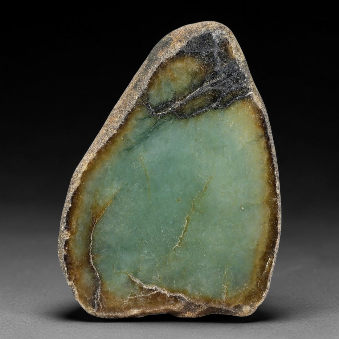 485ct Natural Type A Burmese Brown Rind Teal Jadeite Jade Sliced Rough, 12FA: This specimen is a natural split rough pebble of untreated Type A Burmese jadeite, retaining rugged weathered dark brown outer skin on its reverse side, while its polished cut face features a defined 