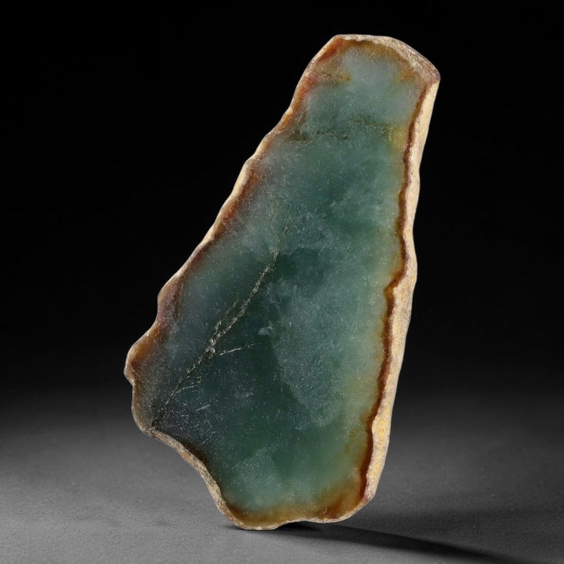 140ct Natural Type A Burmese Teal Jadeite Jade Sliced Rough, 53YN: This specimen is a natural sliced rough piece of untreated Type A Burmese jadeite, retaining a distinct brown weathered outer rind framing its polished interior face displaying smooth, translucent tea