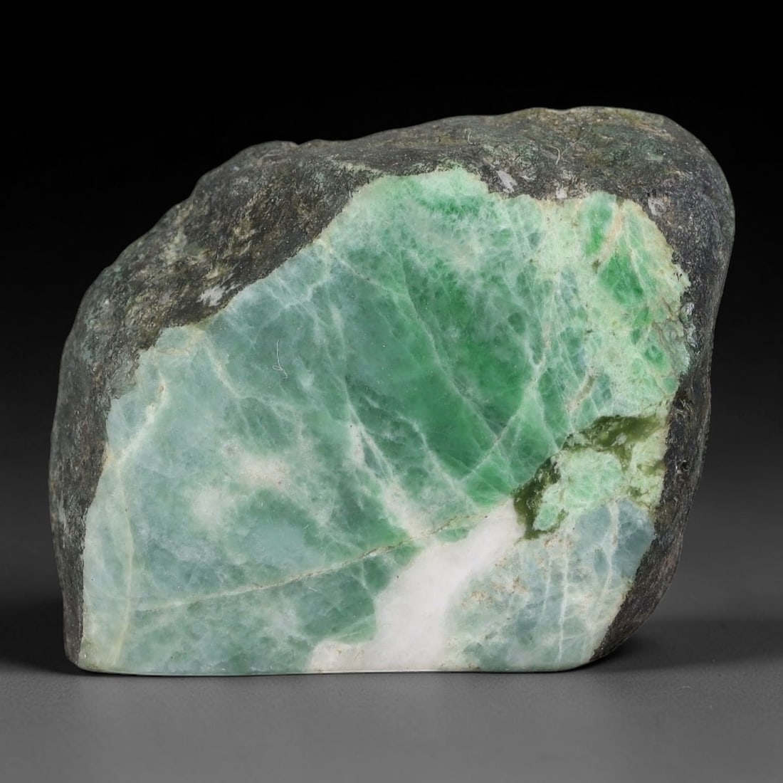 167ct Natural Type A Burmese Jadeite Jade Sliced Rough, 85YN: This specimen is a sliced rough block of natural Type A Burmese jadeite jade. The interior displays natural colour zoning with visible mineral veining and crystalline patterns typical of unprocessed j