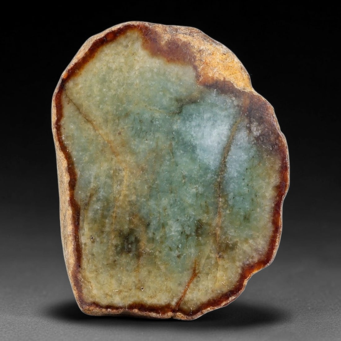 375ct Natural Type A Burmese Two-Tone Red Rim Blue-Green Jadeite Jade Sliced Rough, 18FA: This specimen is a natural sliced rough pebble of untreated Type A Burmese jadeite, framed by an irregular rich reddish-brown oxidized skin rim around its polished interior face. The matrix features b