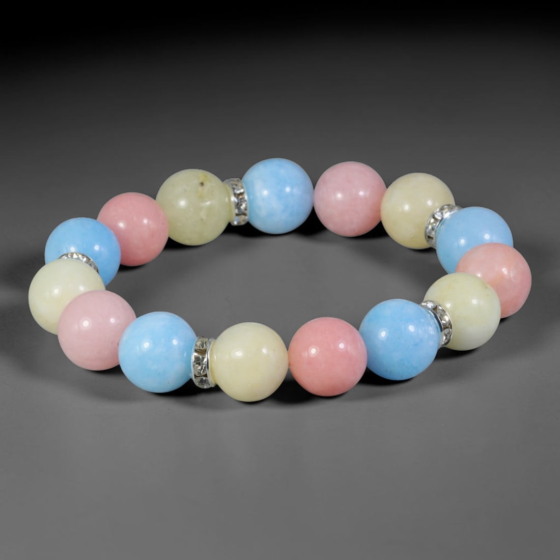 Natural Mixed Stone Beaded Bracelet - Polished Round Bead Strand, 37YM: This elastic stretch bracelet is made of uniformly spherical polished natural mineral beads separated by silvered metal spacers with clear crystalline detailing. The hard stone features soft sky blue,