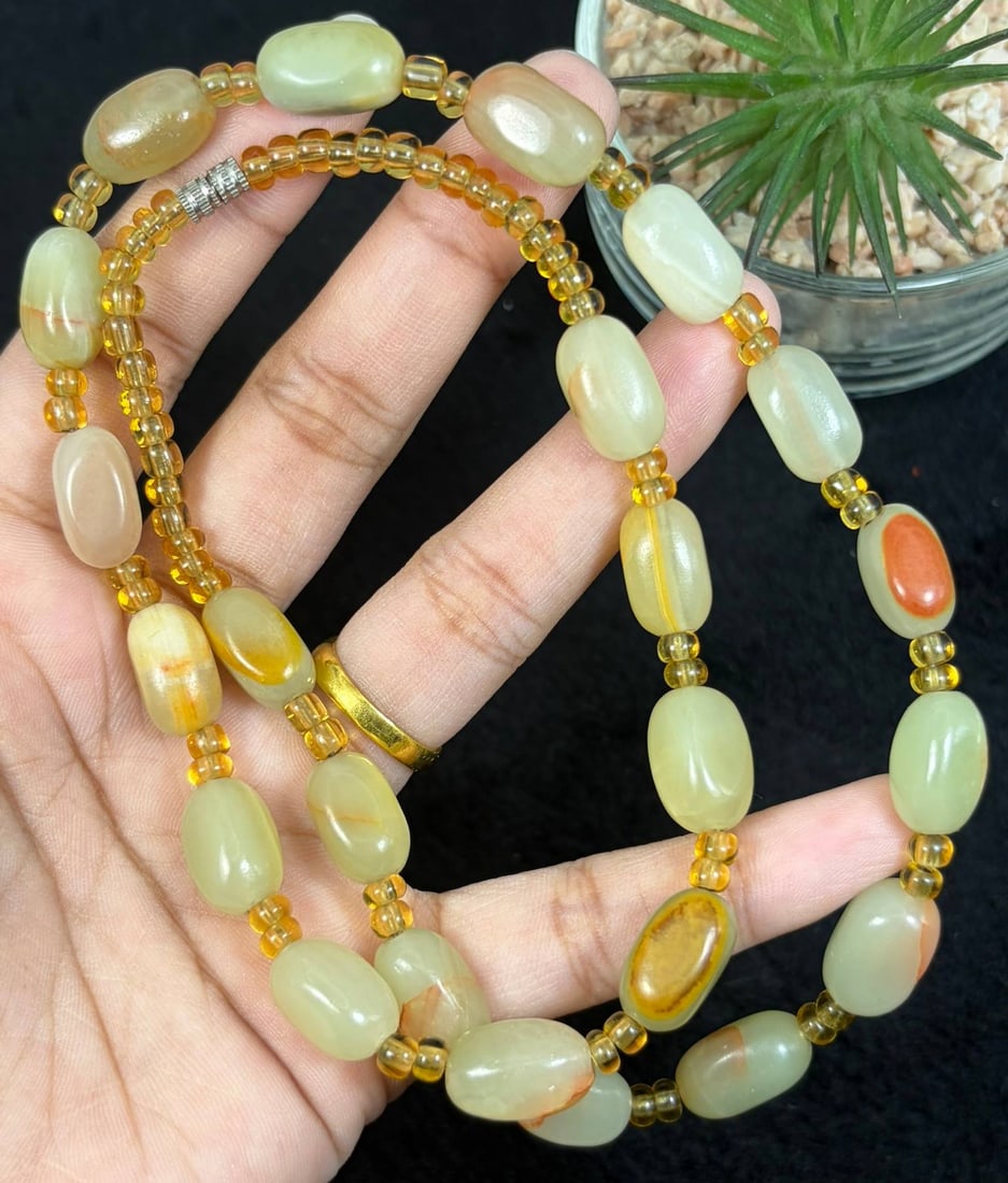 Natural Xinjiang Hetian Jade Pebble Beaded Necklace, 4YM: This elegant necklace features smooth, natural Hetian jade pebbles, strung with small translucent yellow spacer beads and finished with a silver-toned clasp. The jade pebbles display soft pale yellow 